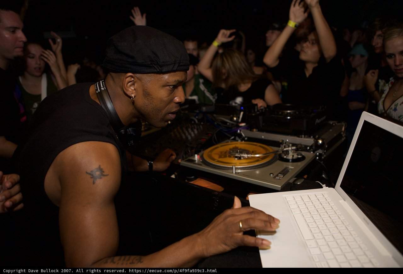 Man in Black Shirt Gets Ready to DJ
