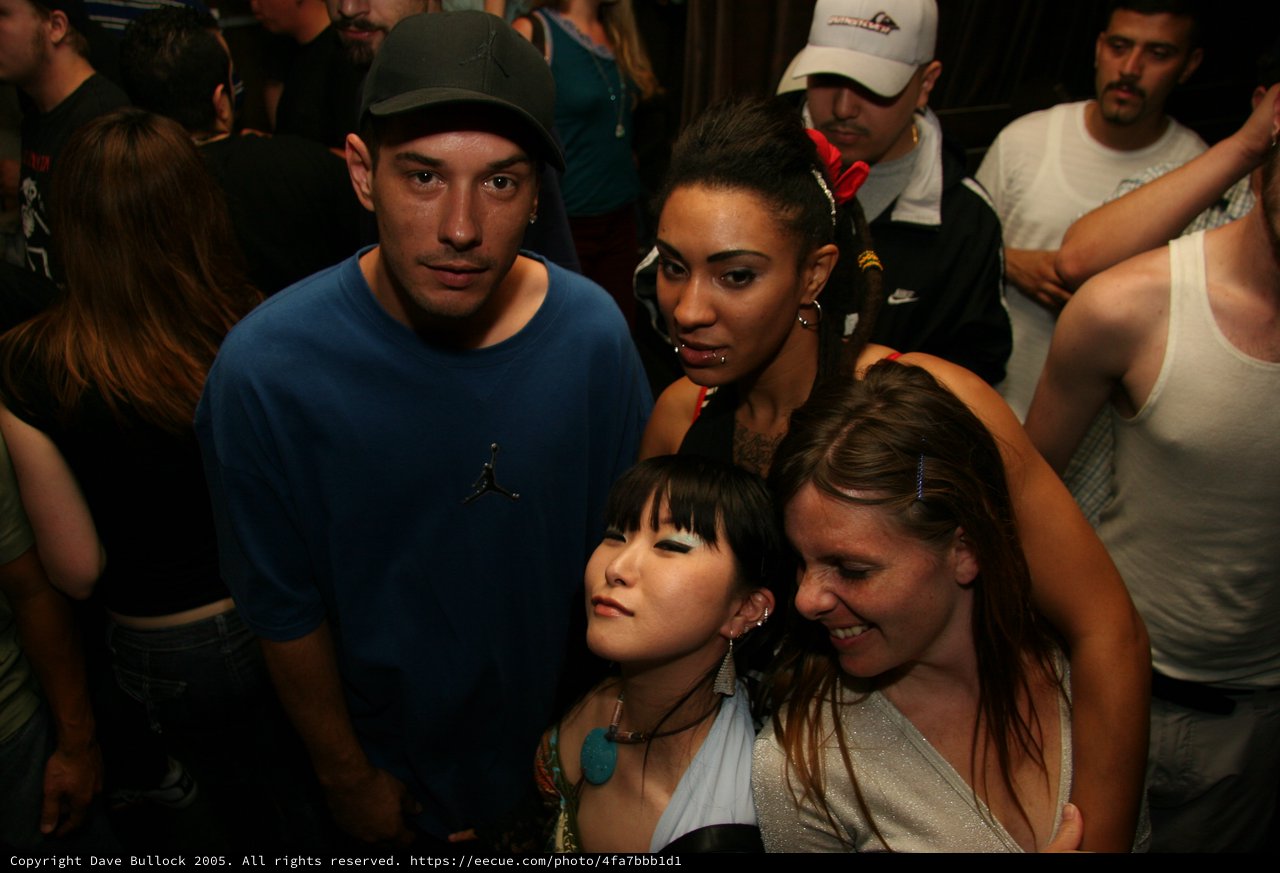 Friends Pose Together at Late Night Club Event