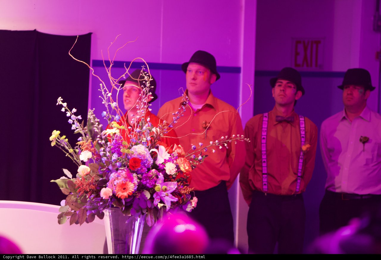Wedding Guests Admiring a Purple Flower Bouquet