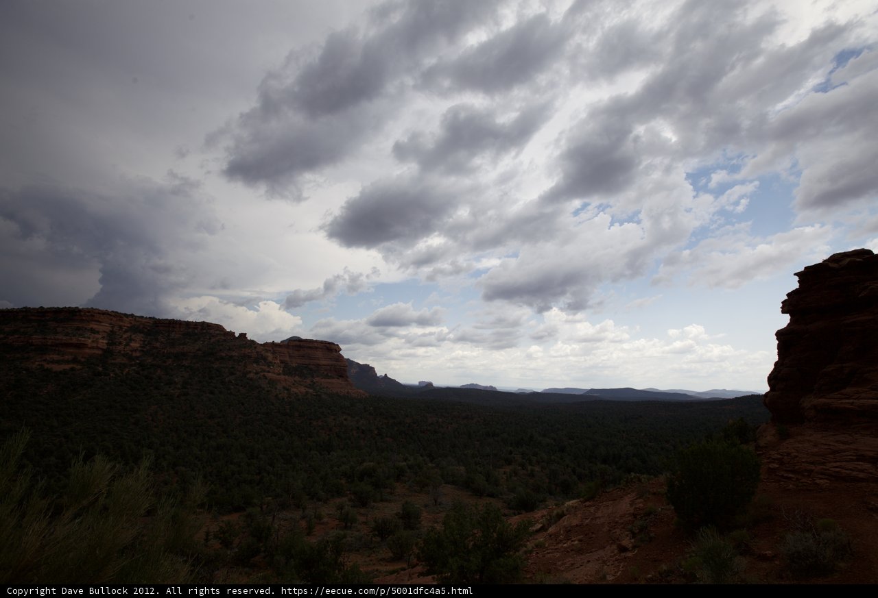 A Mesmerizing View of the Mountain and Clouds from atop the Cliff