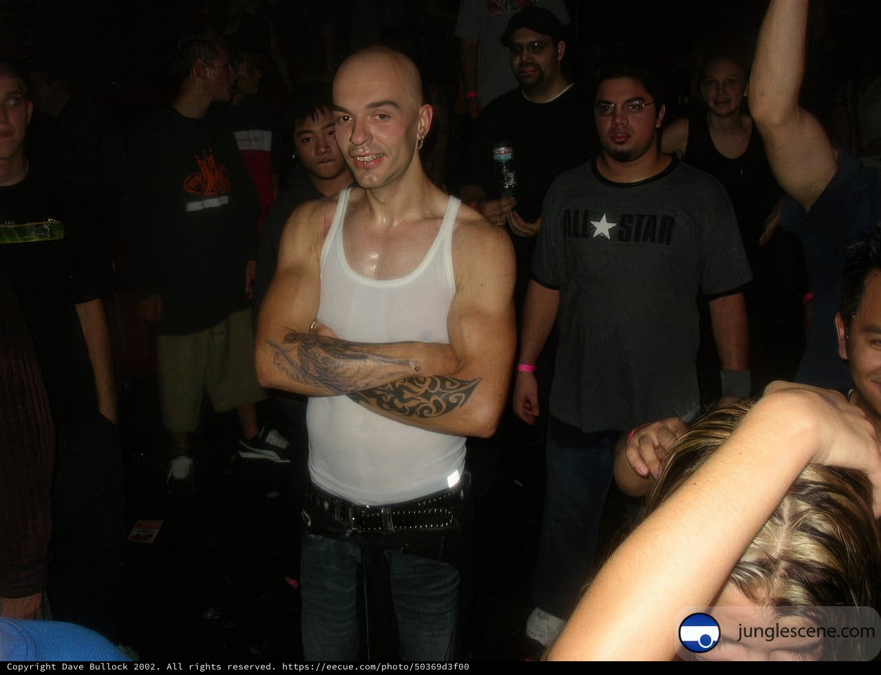 Tattooed Man in Front of a Roaring Crowd