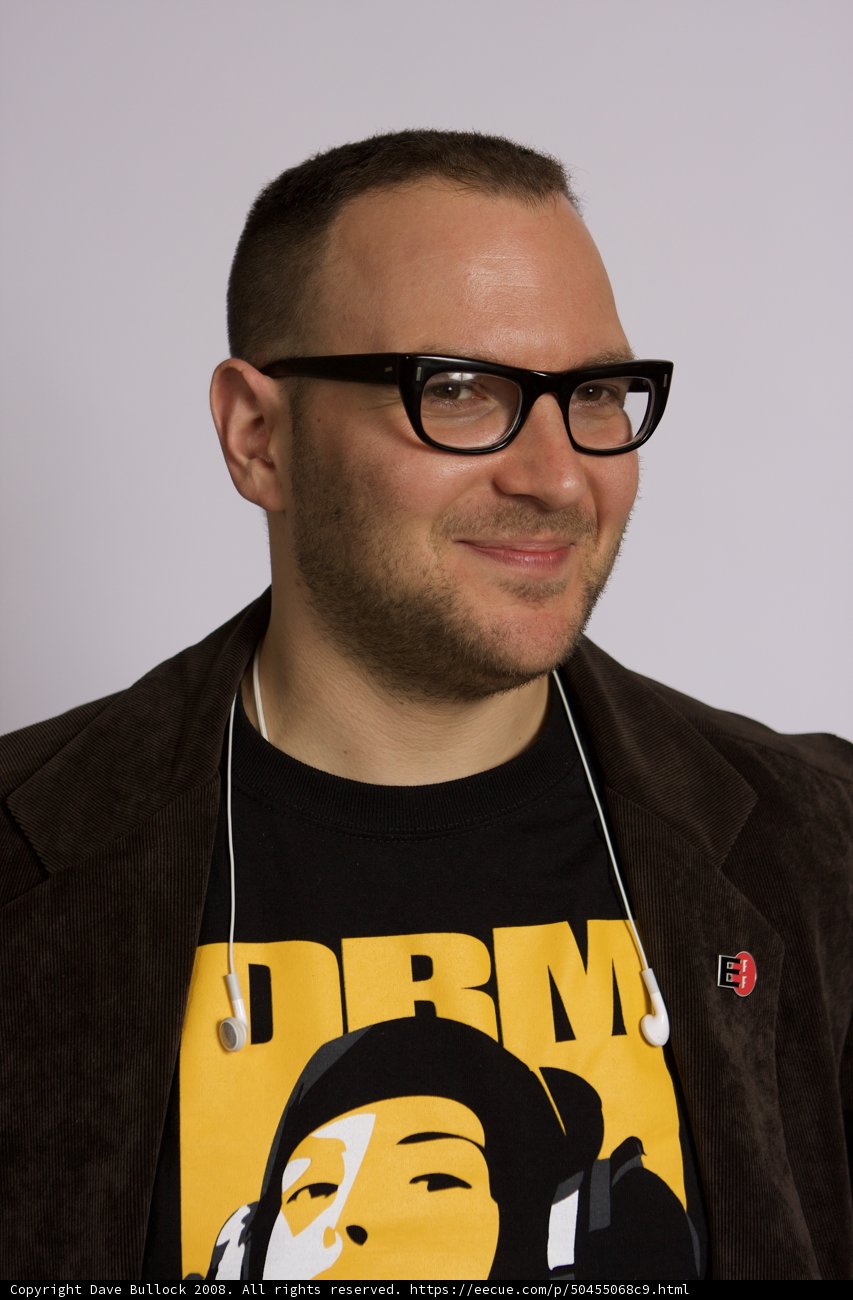 Smiling Man in Black Jacket and Glasses