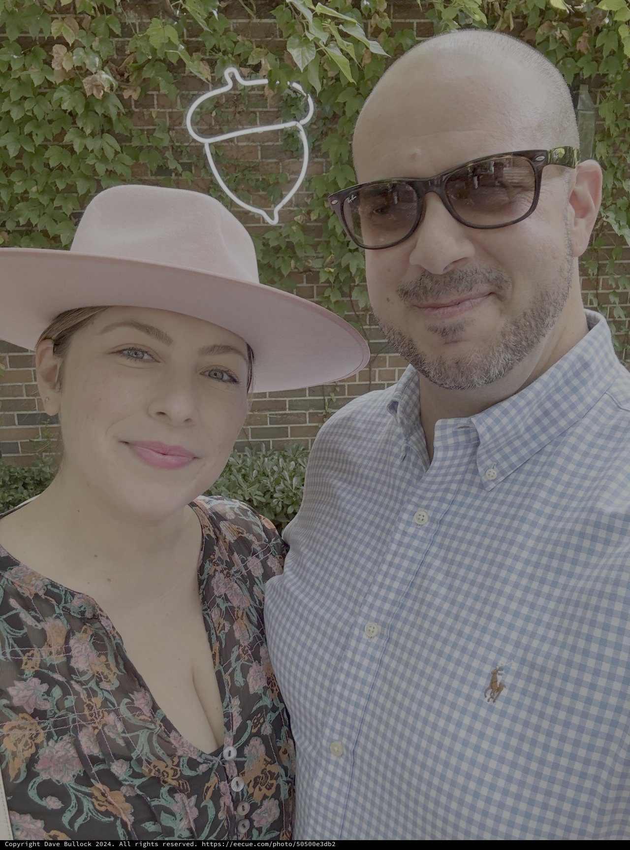 Couple's Casual Portrait Against Ivy-Covered Brick Wall