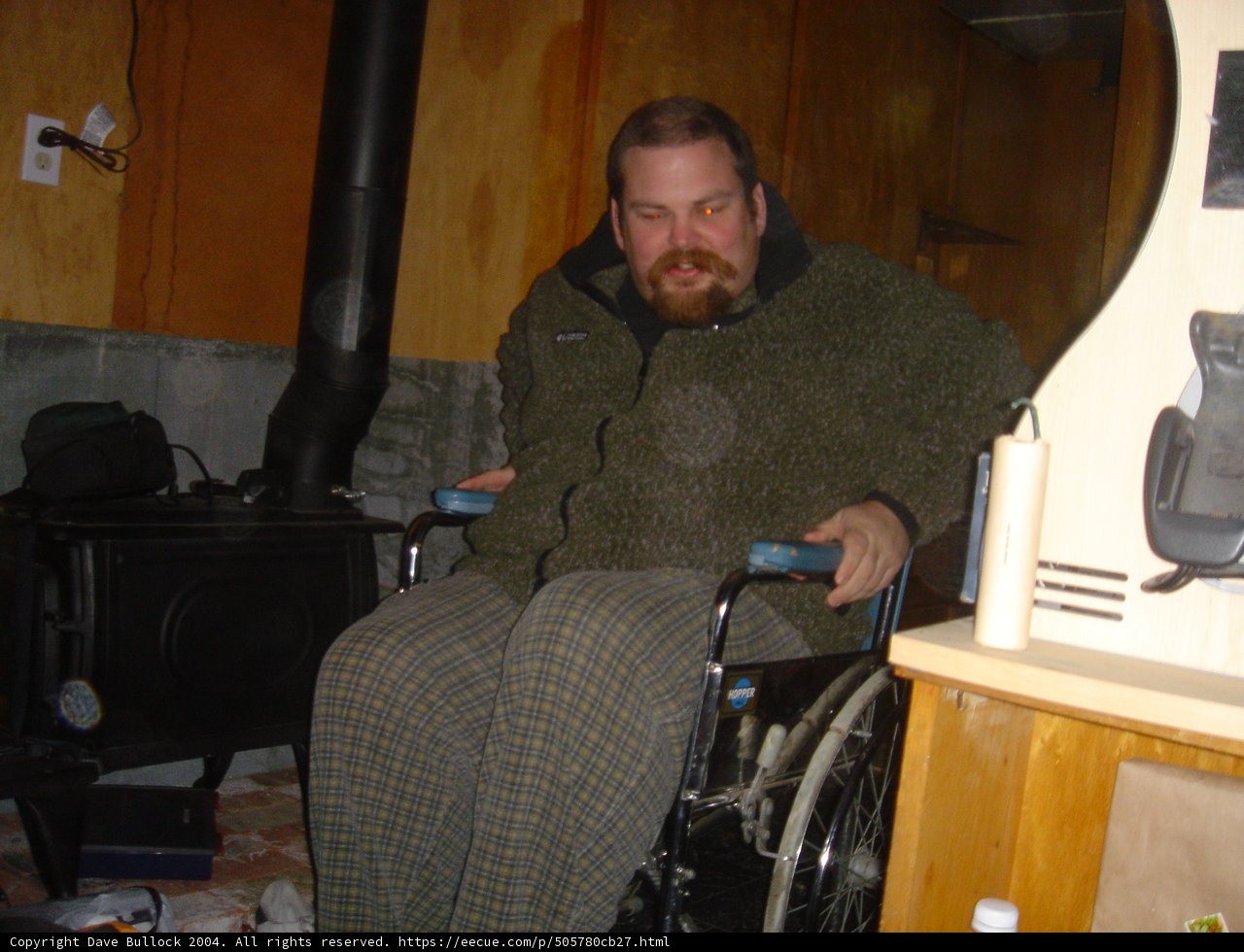 Wheelchair-bound Flea F poses with favorite armchair