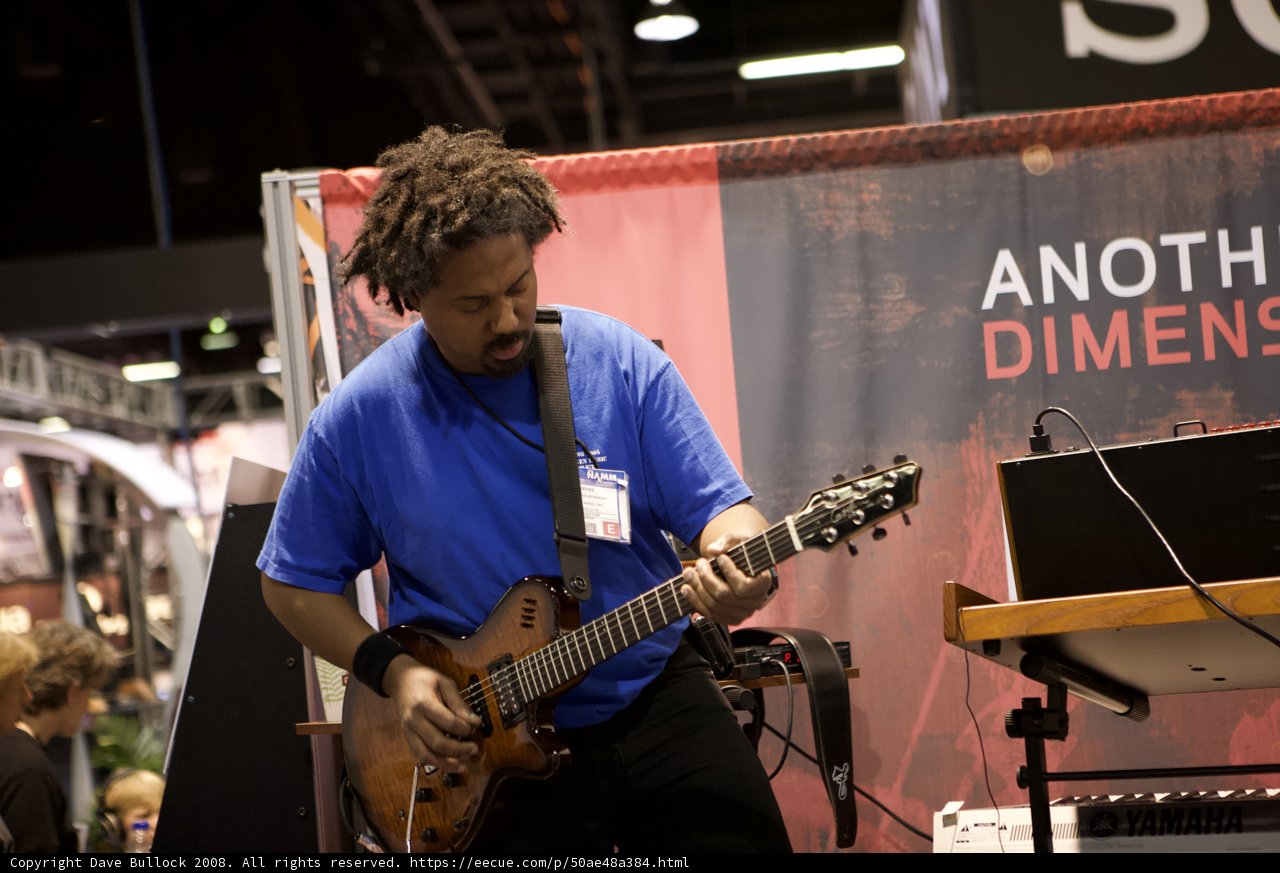 Man playing an electric guitar at 2008 NAMM concert