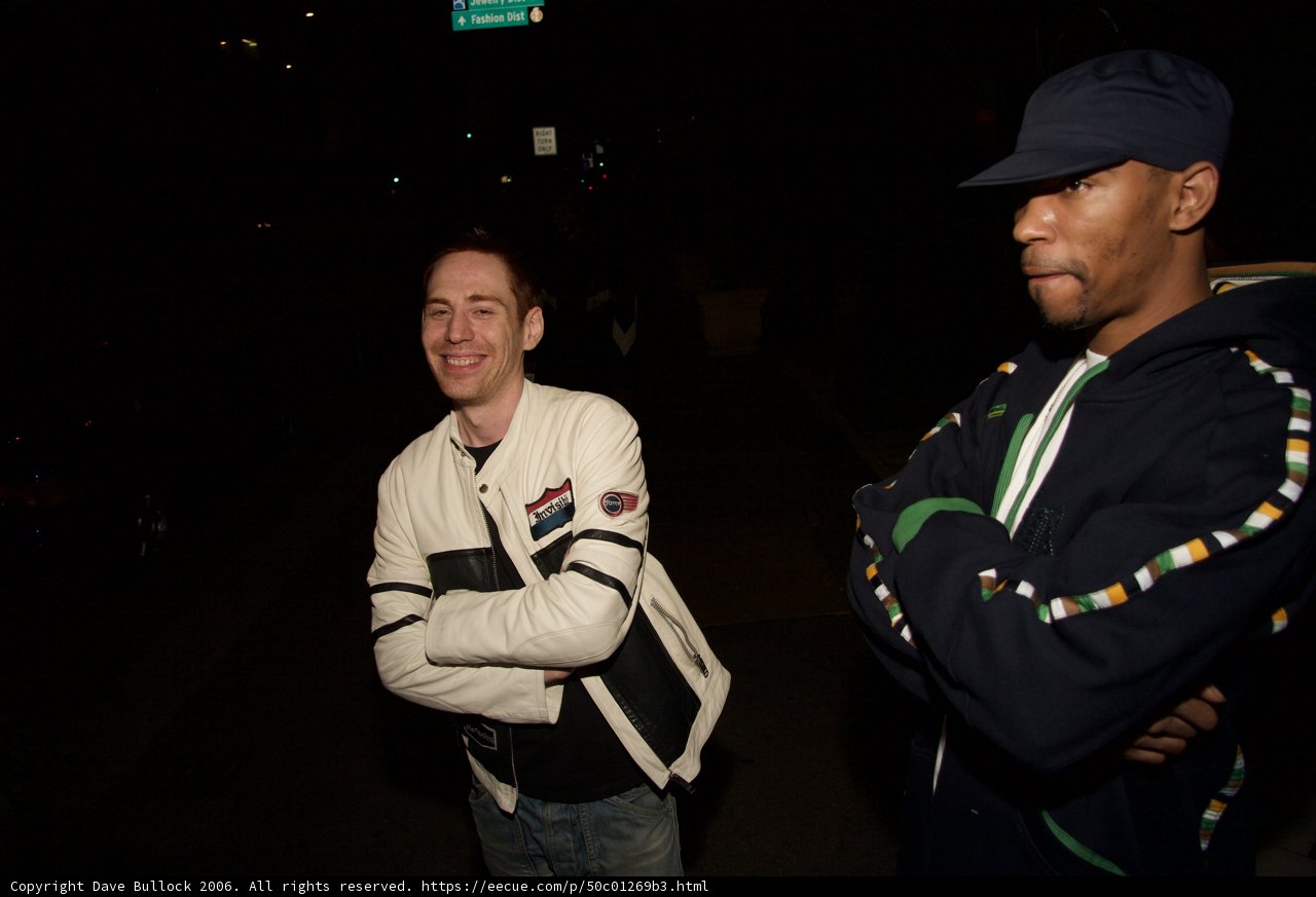 Two Men Standing Together at Night