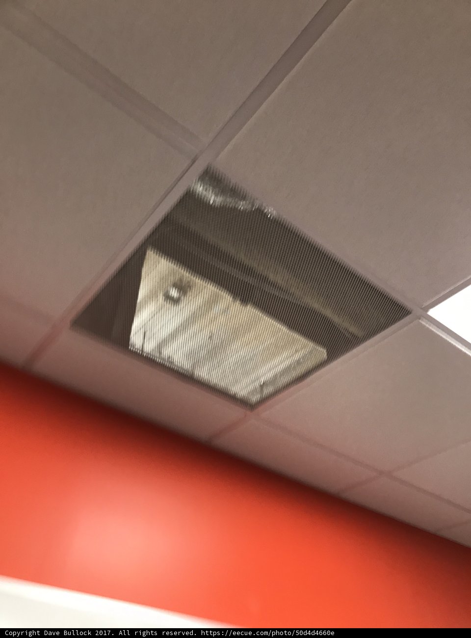 Damaged Ceiling with Light Bulb