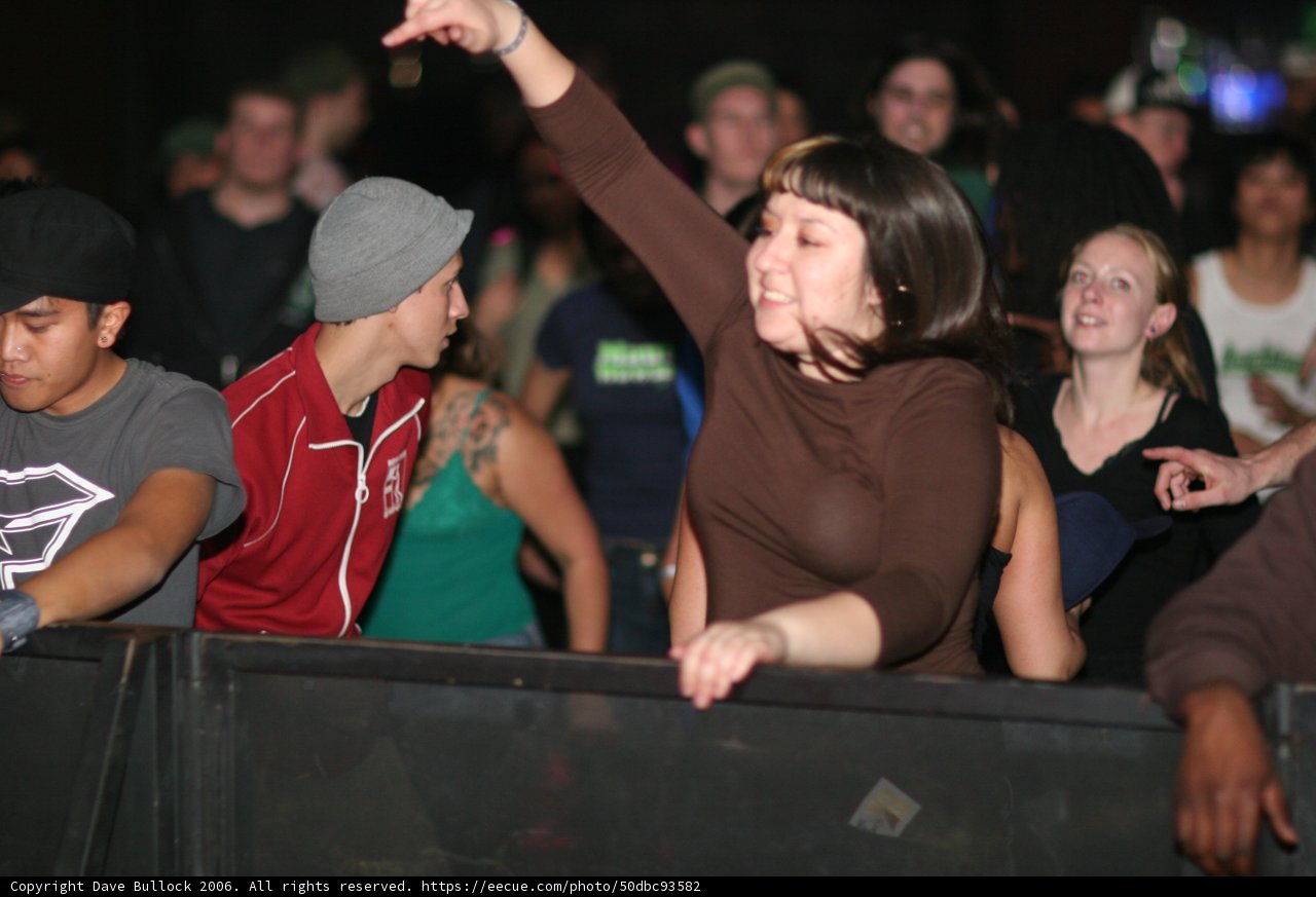 Brown Shirted Woman in a Sea of Hats