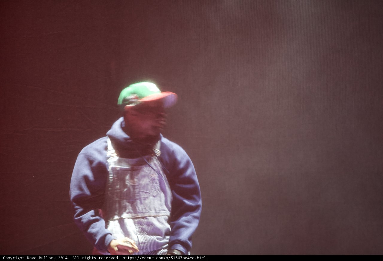 Man in Overalls and Hat Takes the Stage