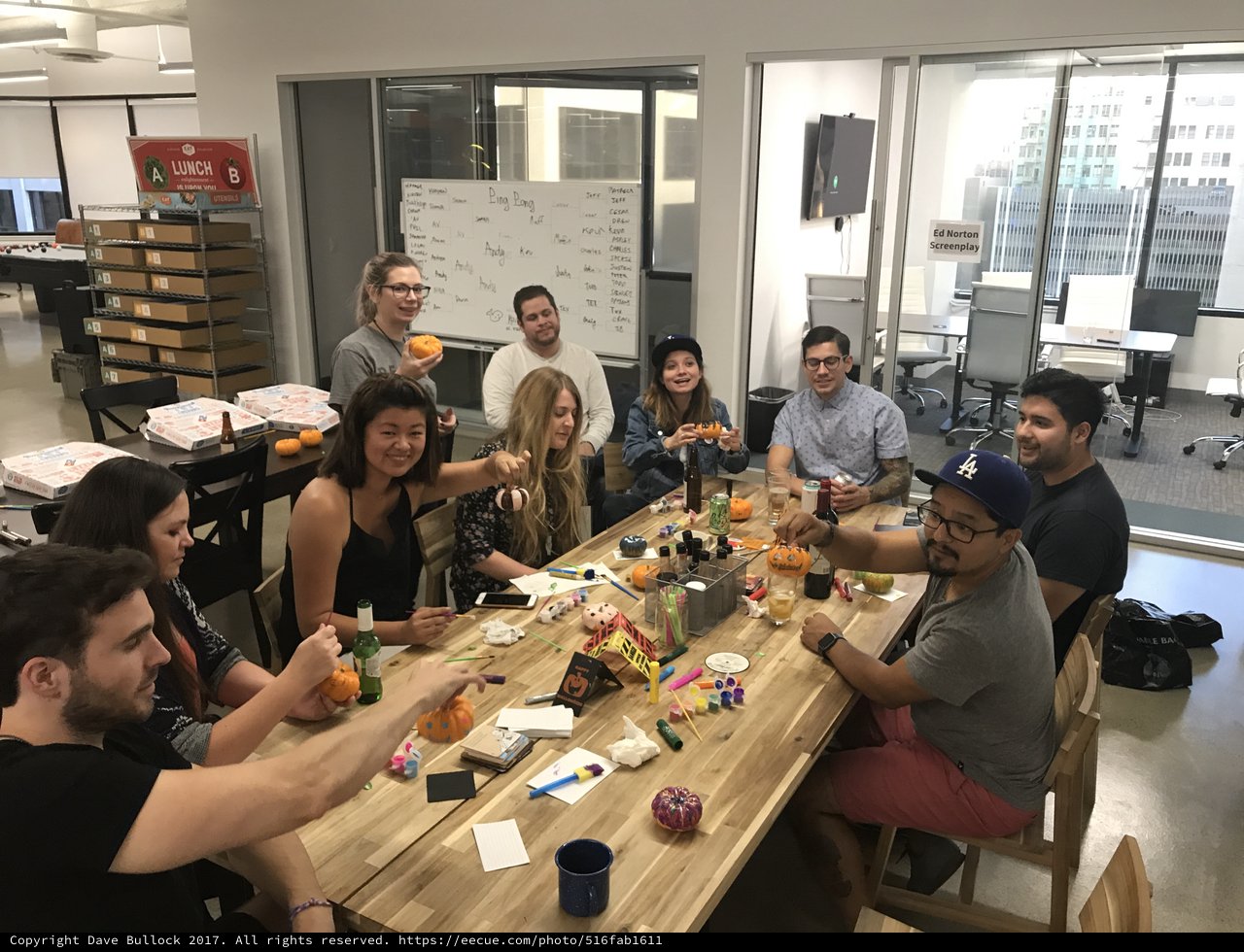 Friends Decorating Mini Pumpkins at Office Halloween Party