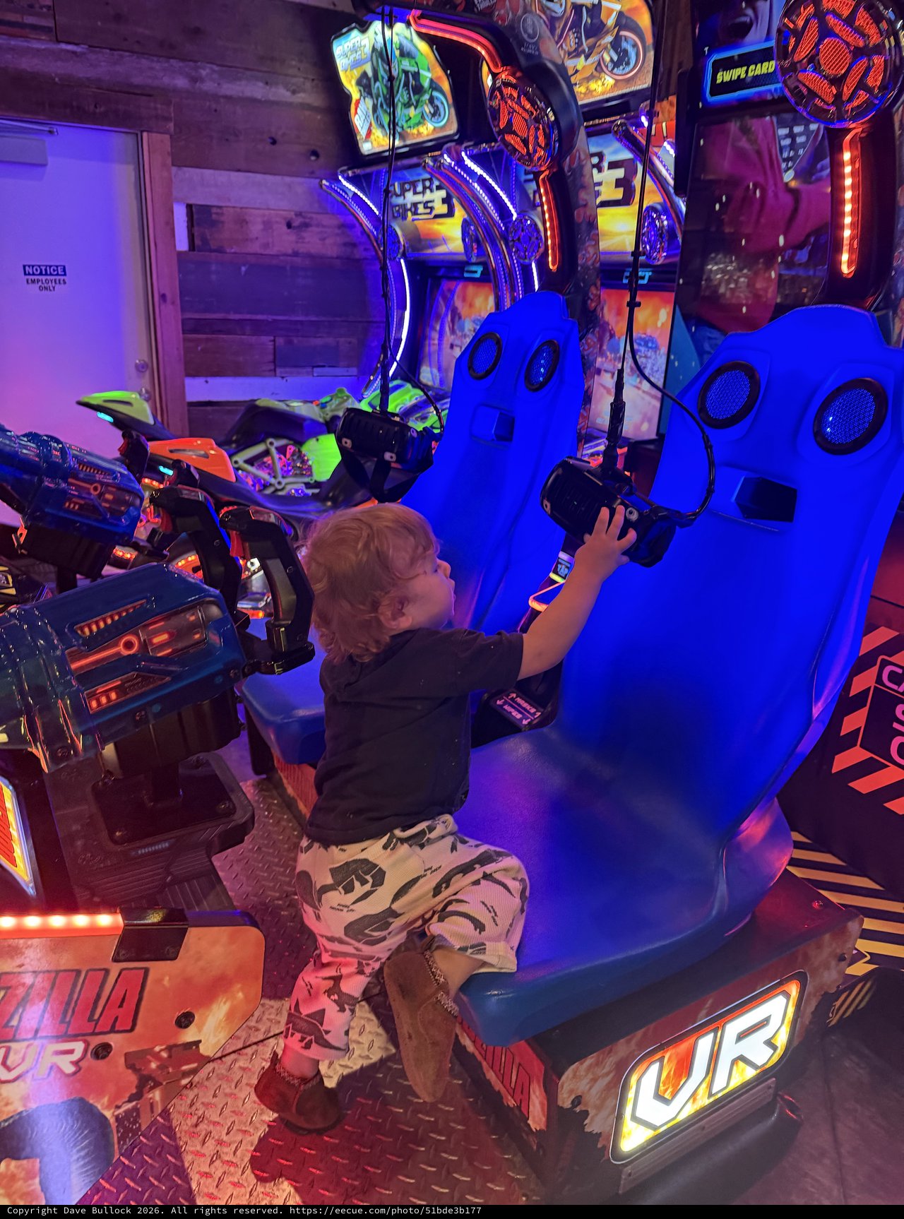 Child Playing Virtual Reality Motorcycle Racing Game in Arcade
