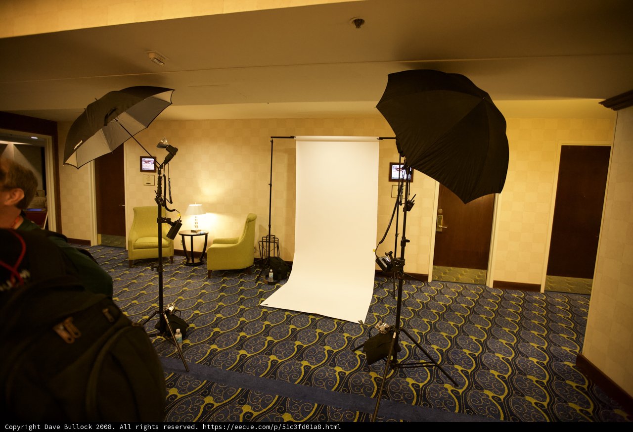 Two men pose in a photo studio
