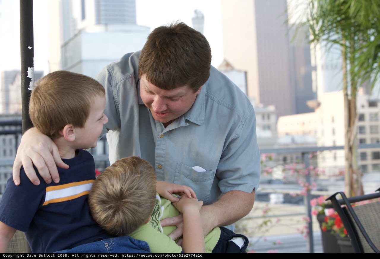 Father Shares Tender Moment With Two Young Sons