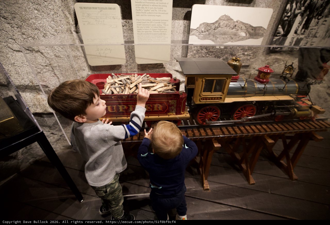 Young Brothers Exploring Vintage Train Exhibit at Museum