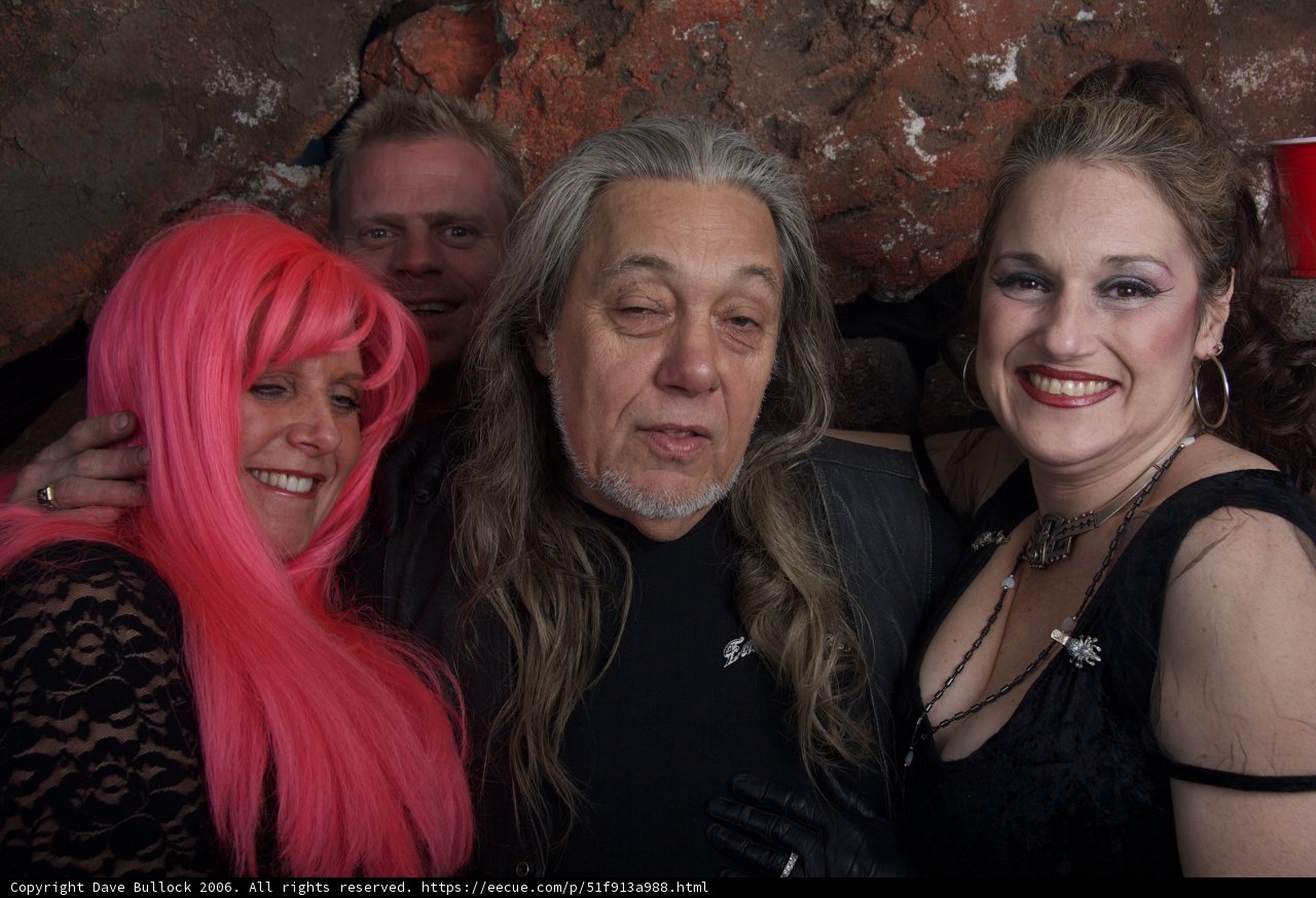 Pink-haired man and women strike a pose