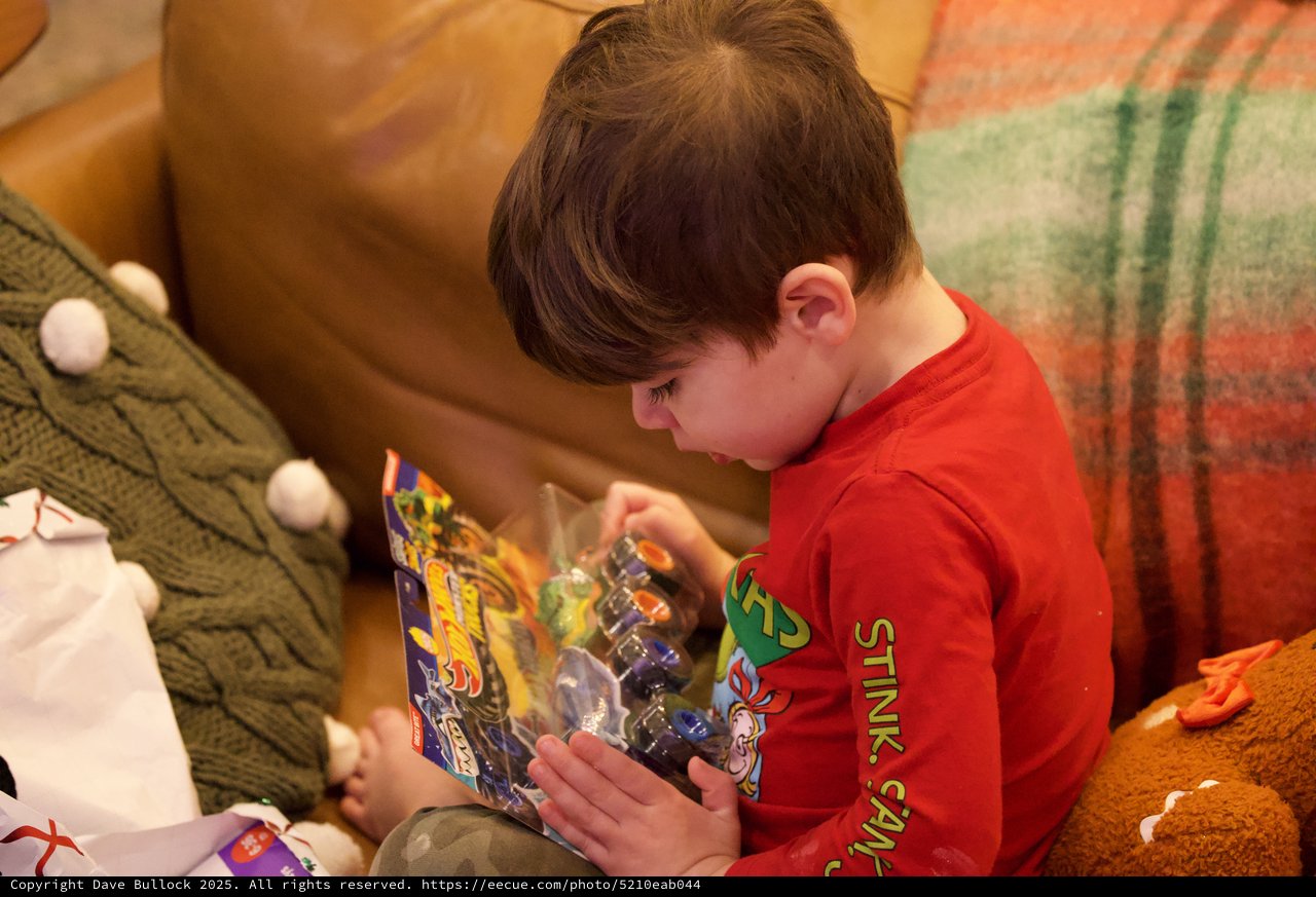 Boy Opening Action Figure Toy on Christmas Morning