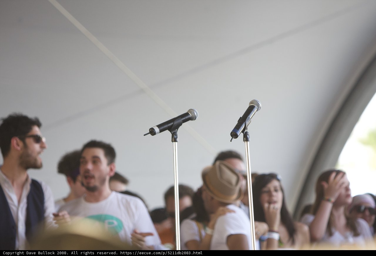 DJ AM on stage with two microphones