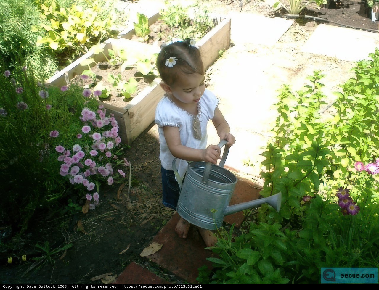 Young girl tending to her outdoor herbal garden