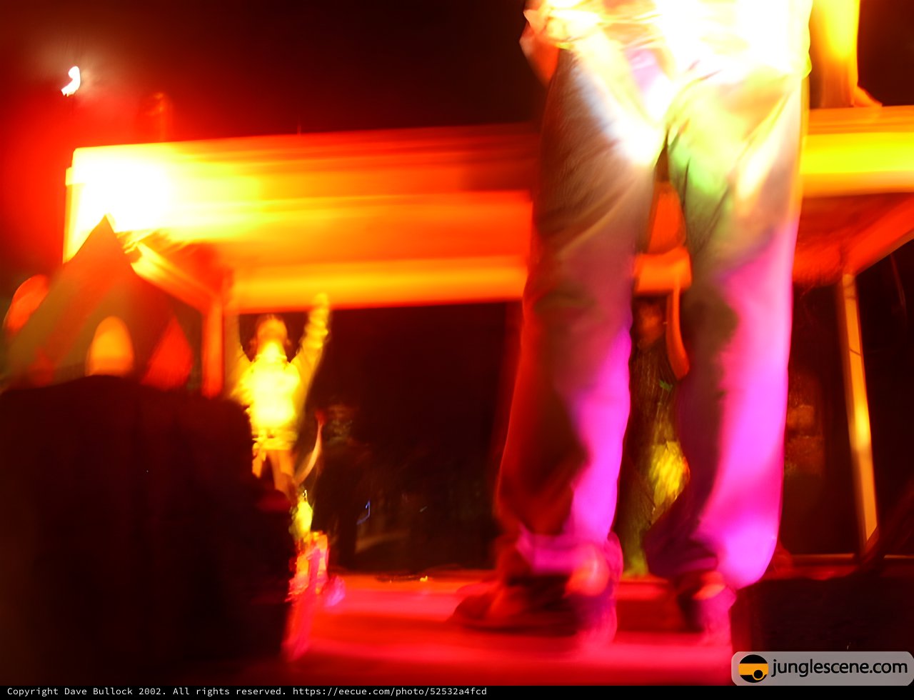 Dancer in Motion Under Vibrant Pink and Orange Stage Lights