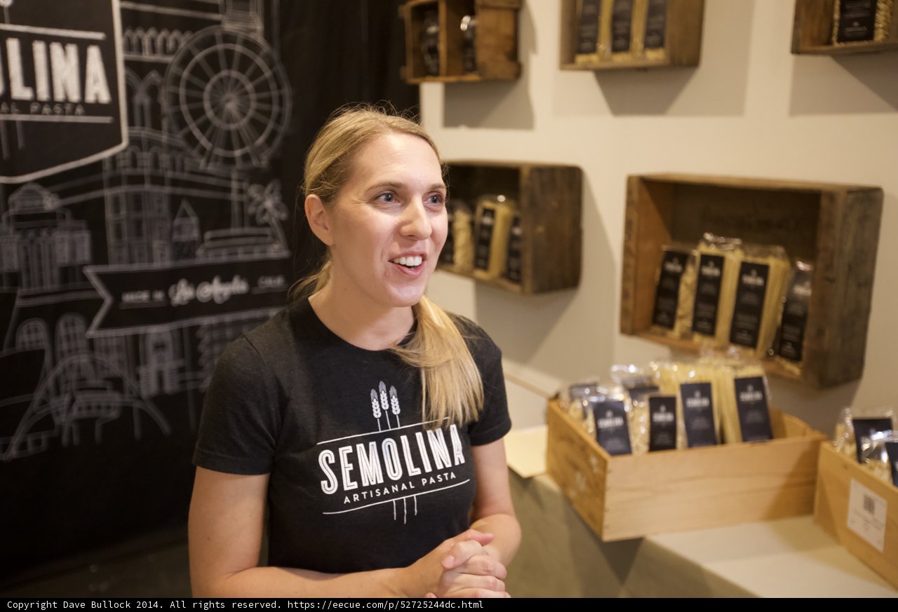 A Woman Poses with Coffee Display at a Los Angeles Shop