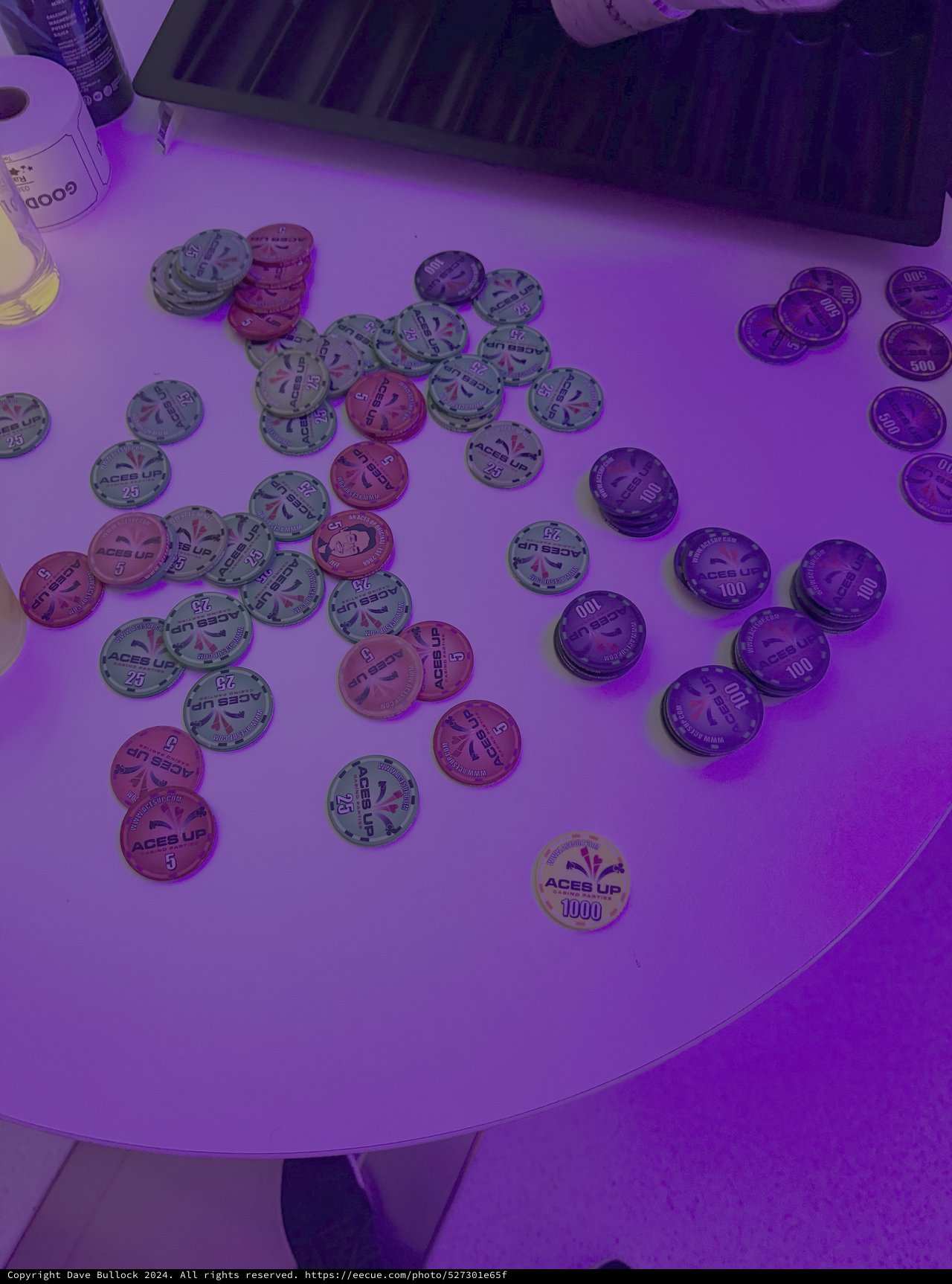 Poker Chips Under Purple Casino Lighting