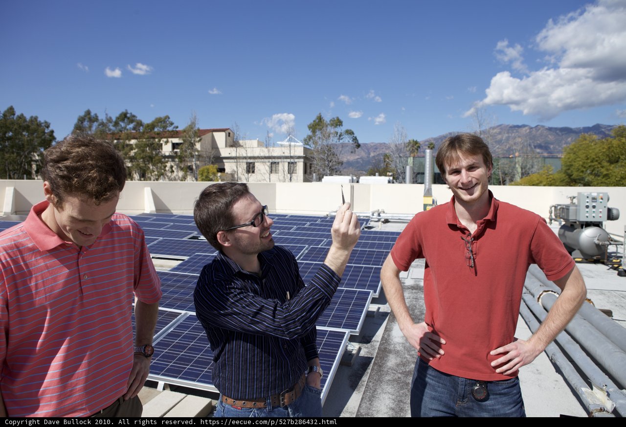 Three Men Working on Solar Panels
