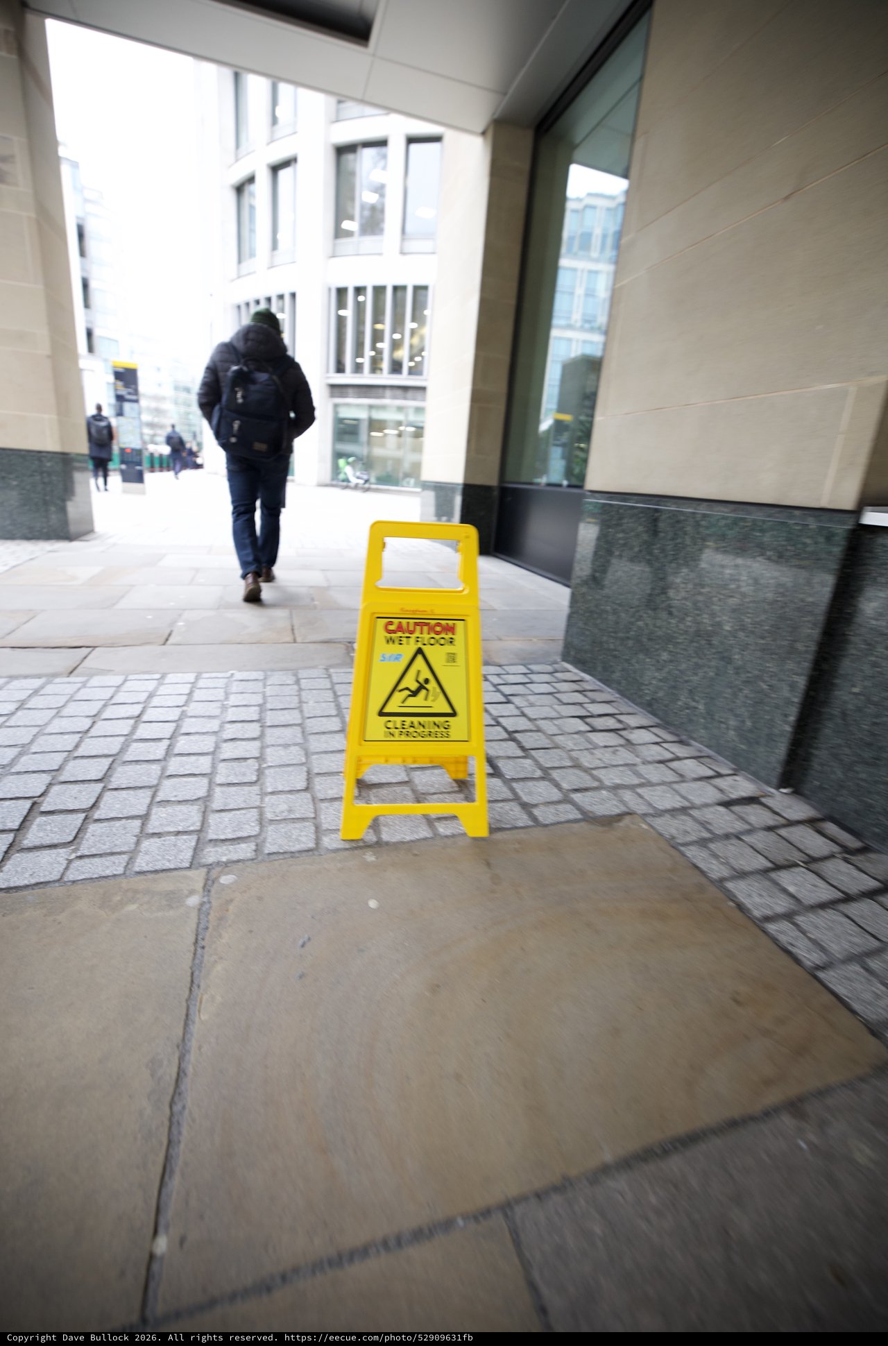 Wet Floor Caution Sign in Modern Building Corridor