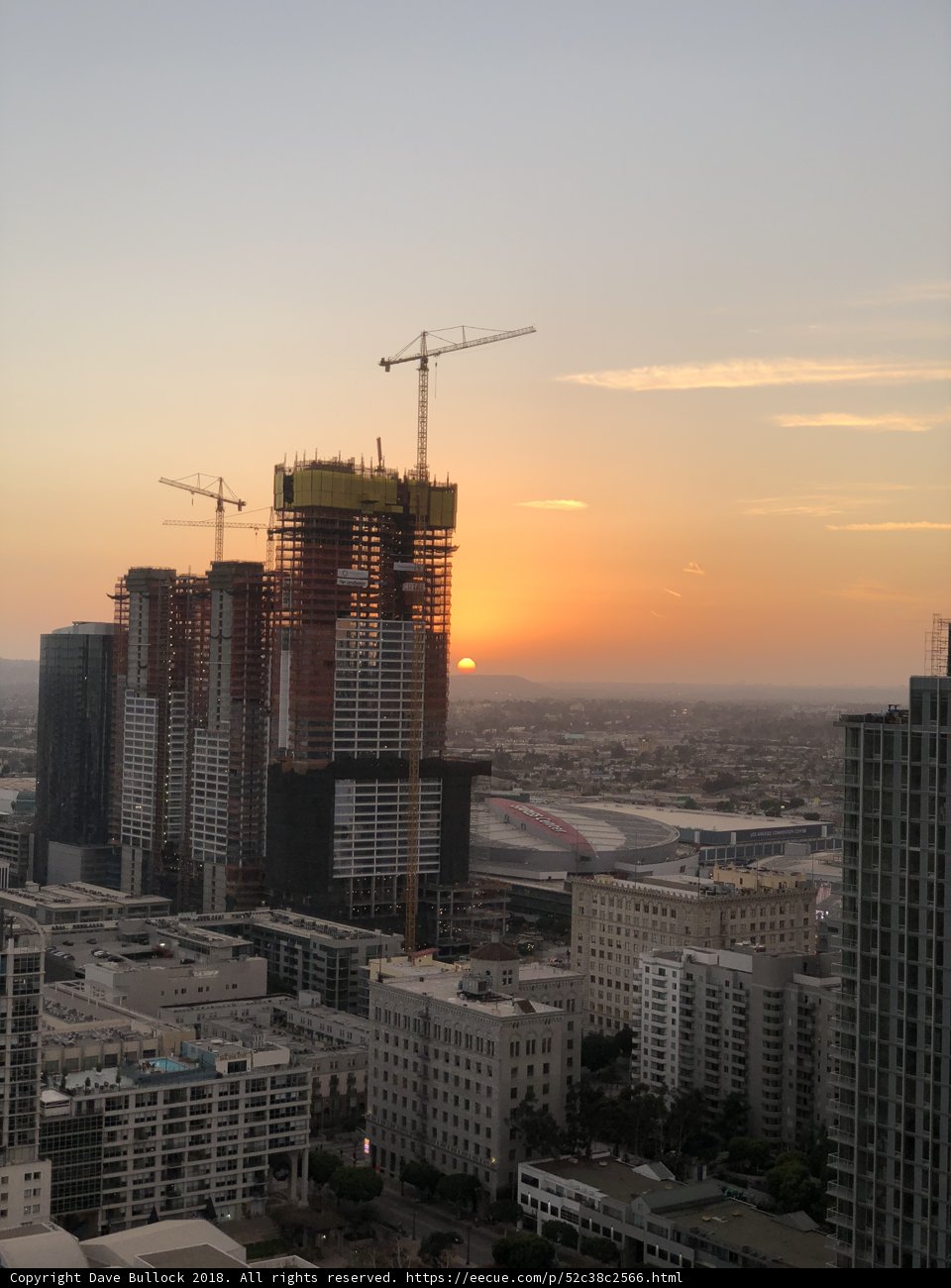 Urban Sunset with Construction Cranes