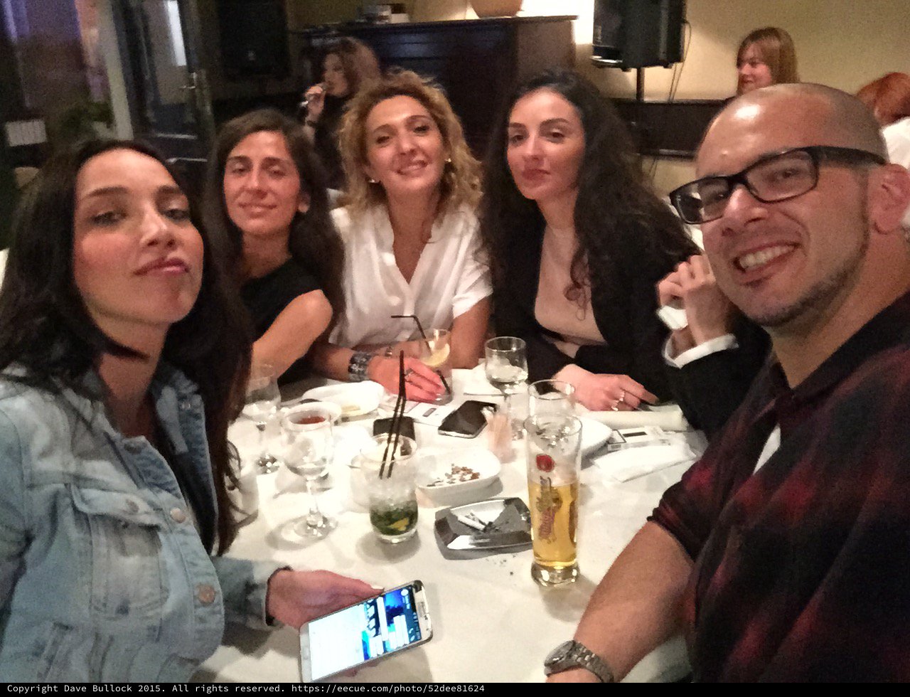 Friends Laughing Together at Restaurant Dinner Table