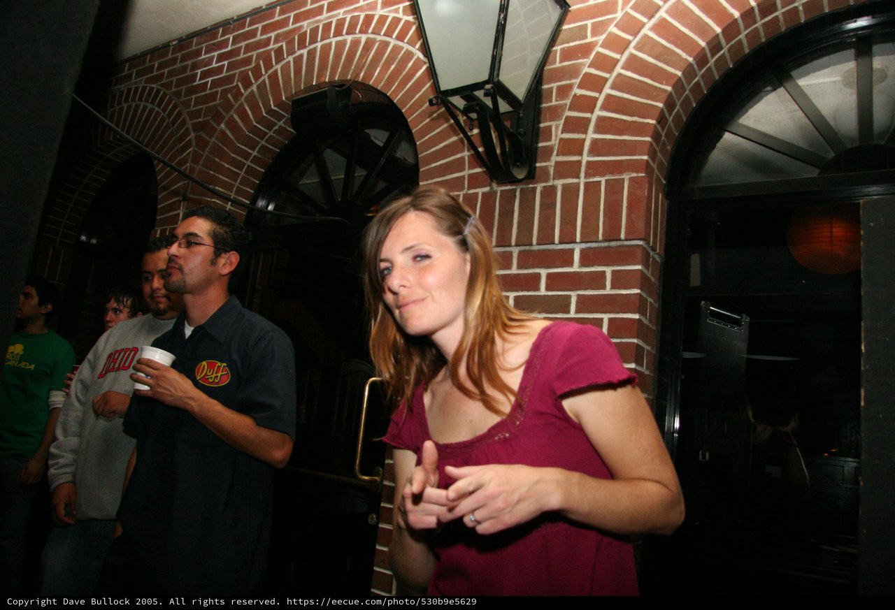 Young Woman Smiling at Indoor Brick Venue Night