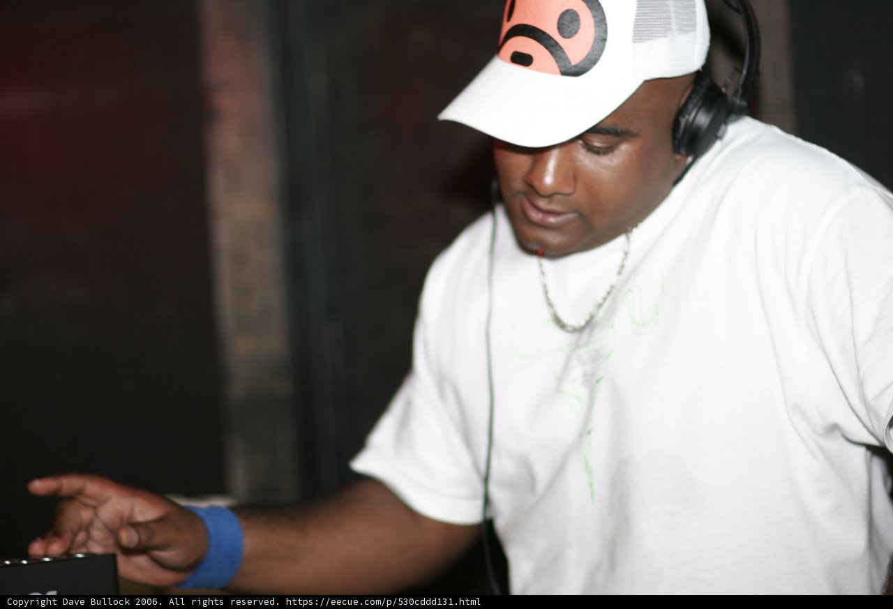 White Shirted Man with Baseball Cap and Headphones