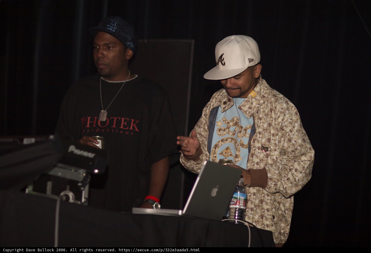 Two Men in Baseball Caps with Laptop
