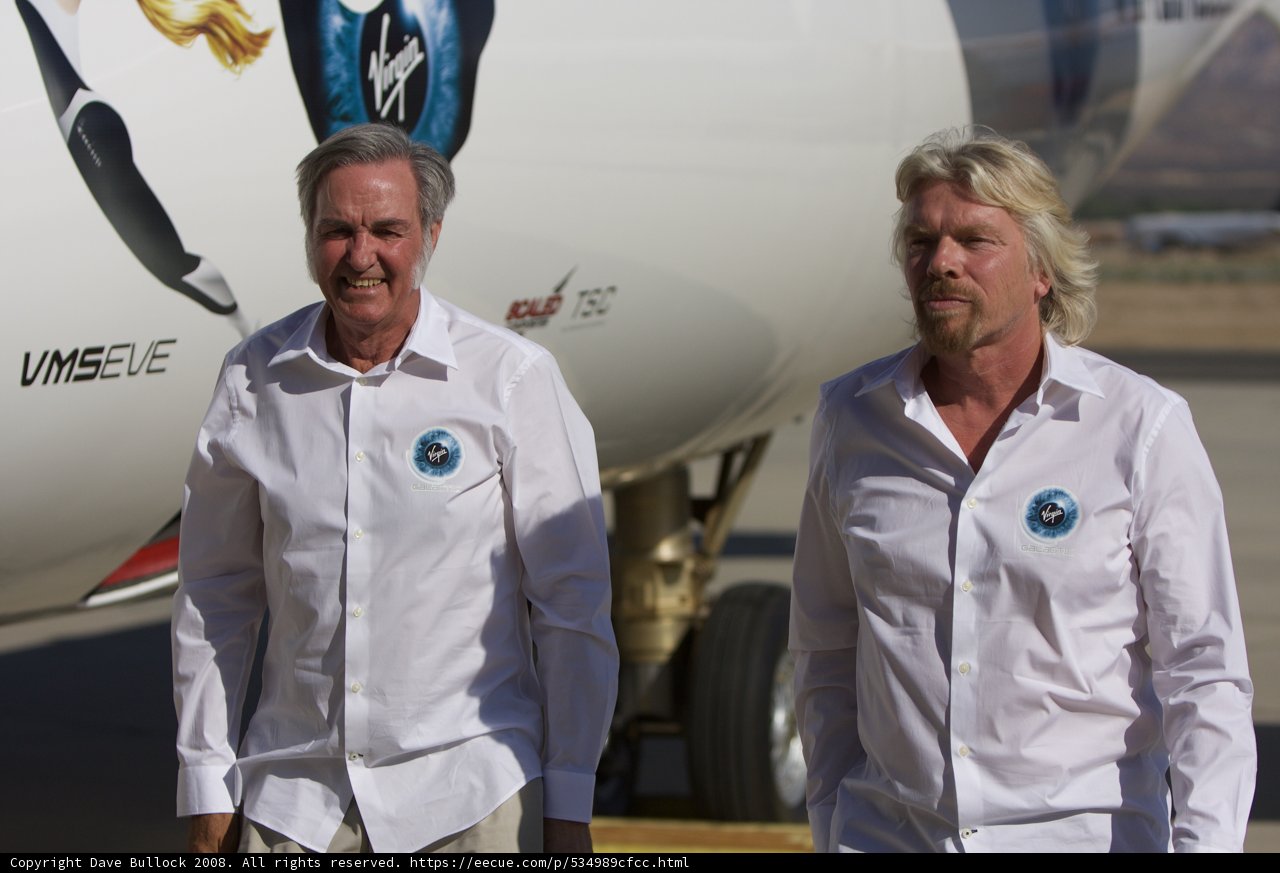 Two Men in White Shirts Posed by an Airplane