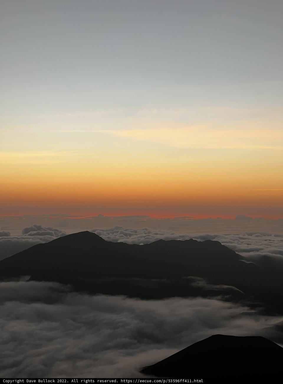Sun rising over the clouds from Mauna Kea