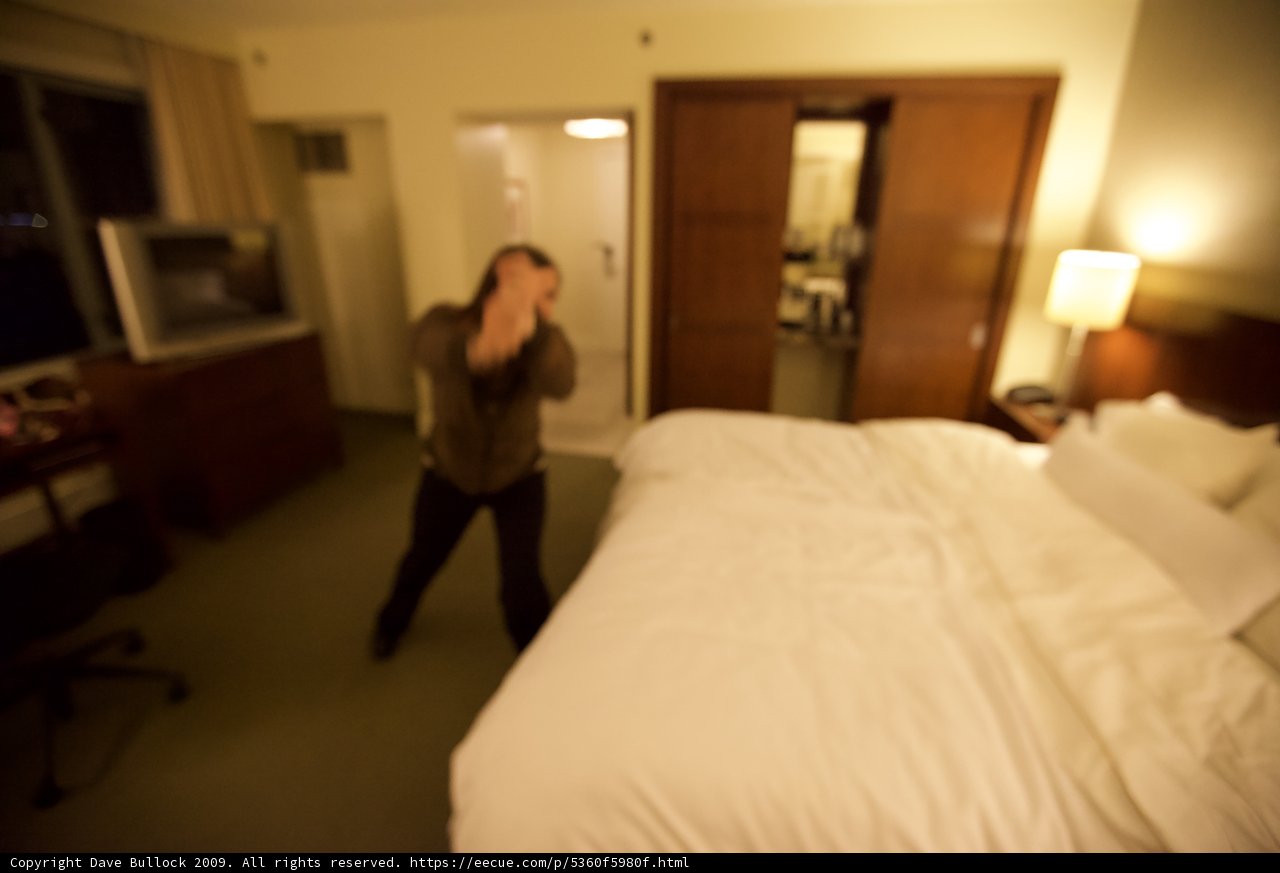 Blurry Hotel Room Man with Computer Monitor