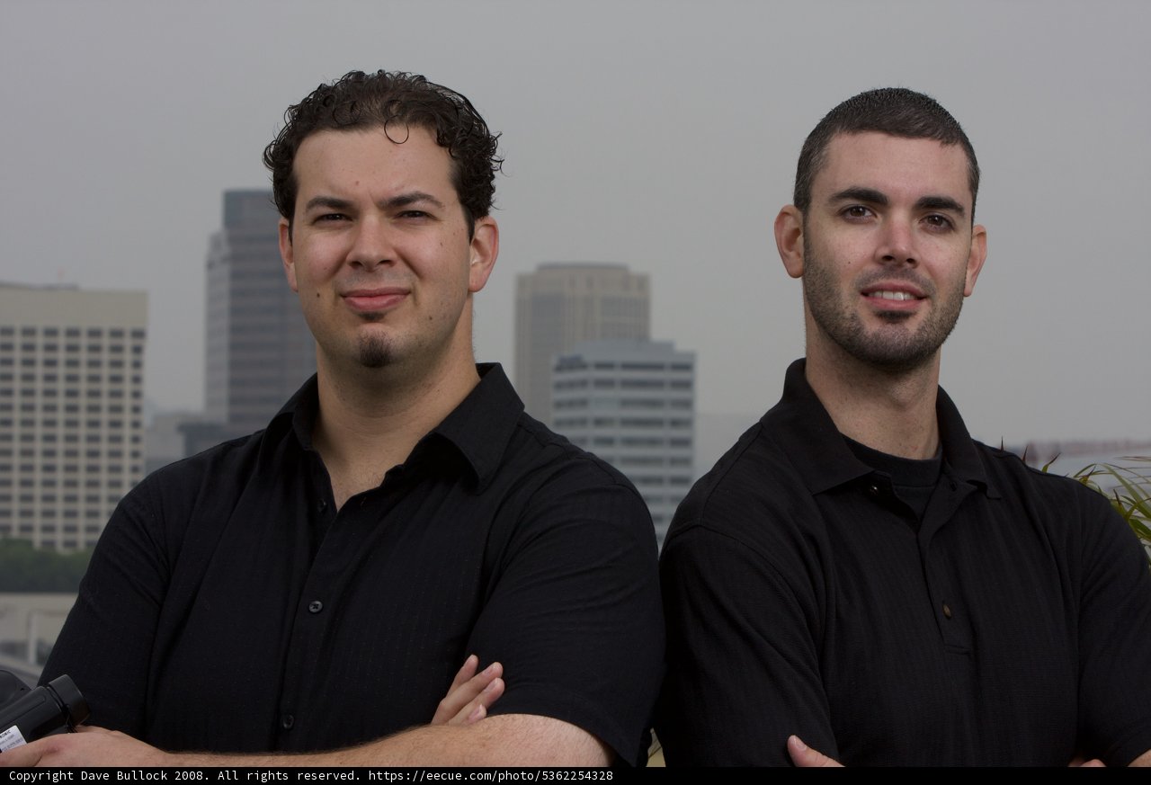 Two Happy Men in Black Shirts at the Skyscraper
