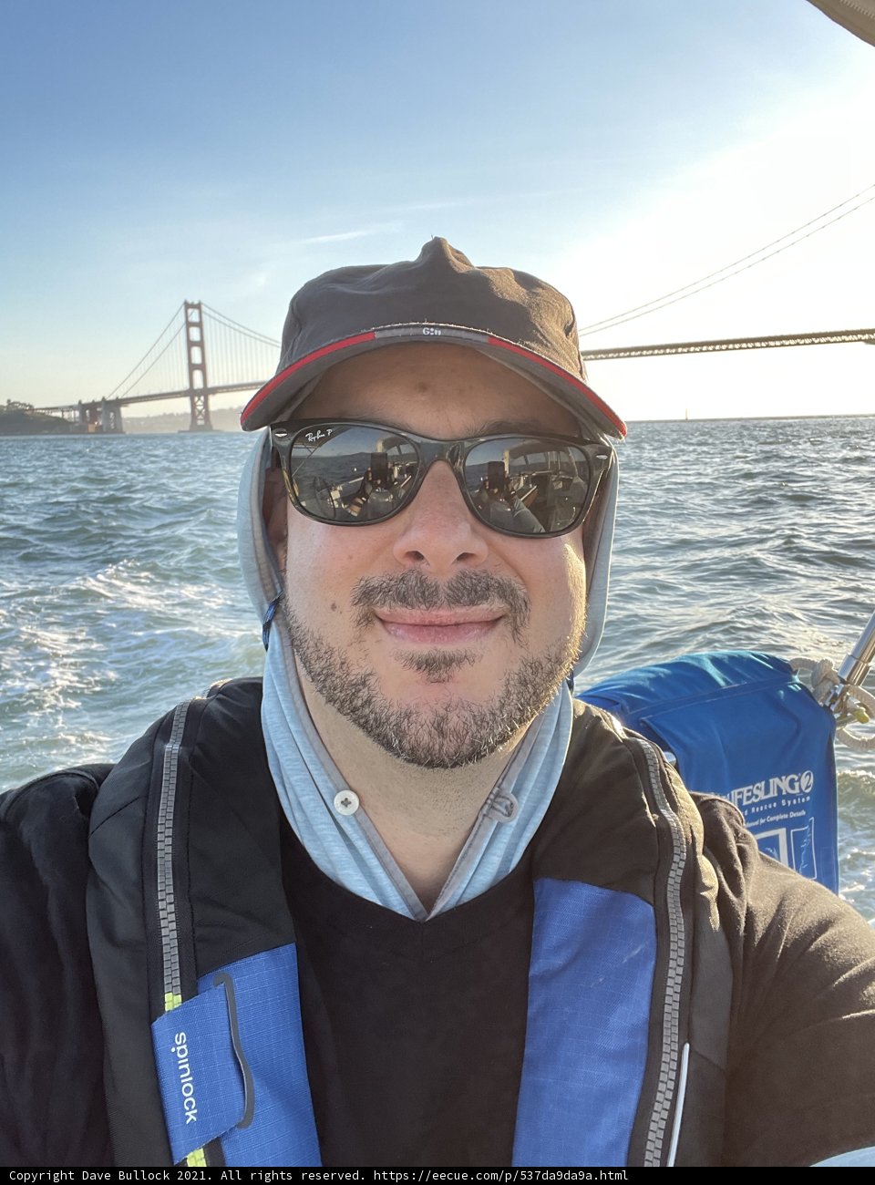 Man in Sunglasses and Hat Enjoys Scenic Boat Ride in San Francisco Bay