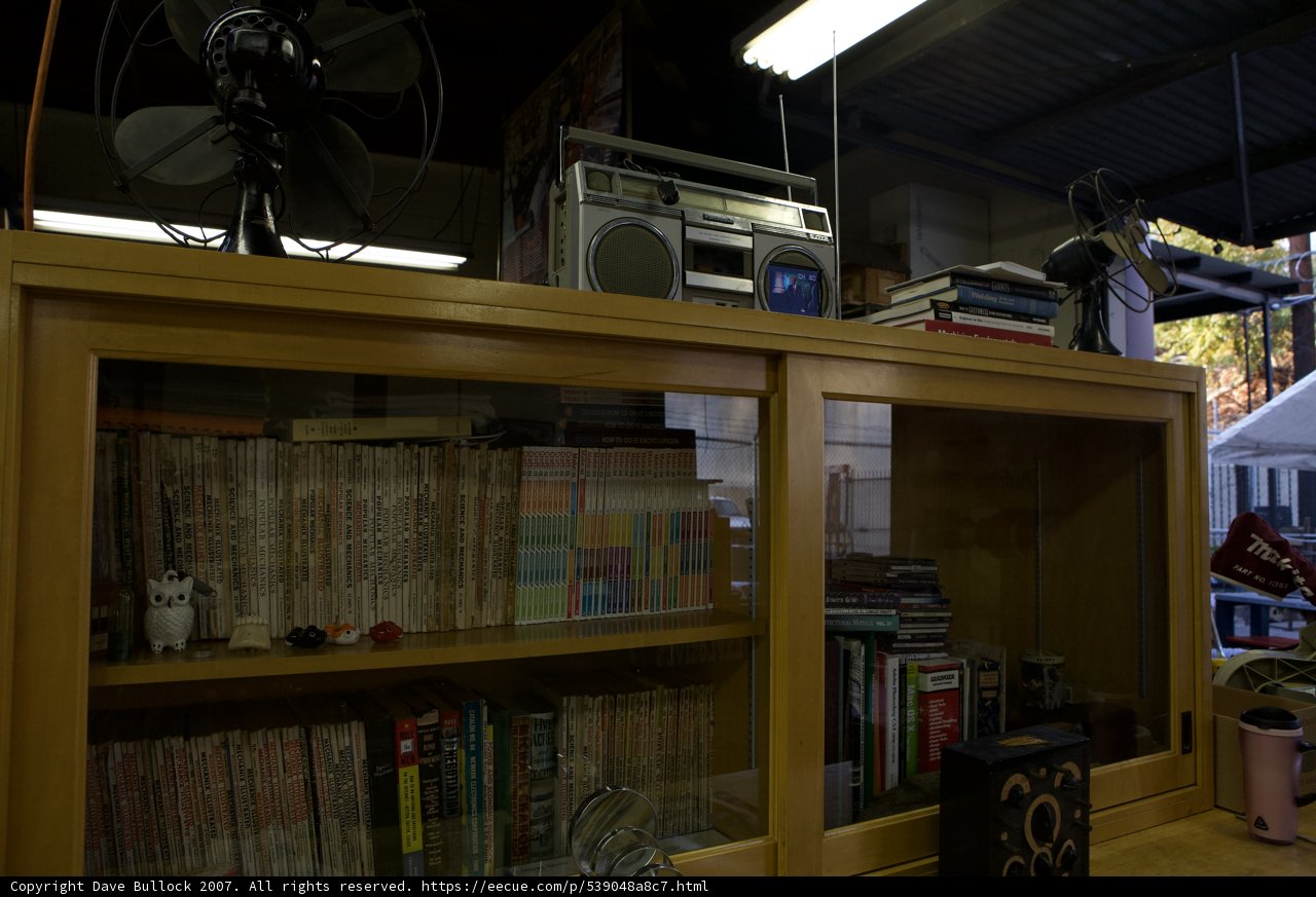 Wooden Cabinet with Books and Fan