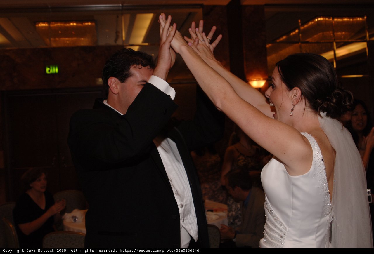 Bride and Groom High-Five During Wedding Reception Dance
