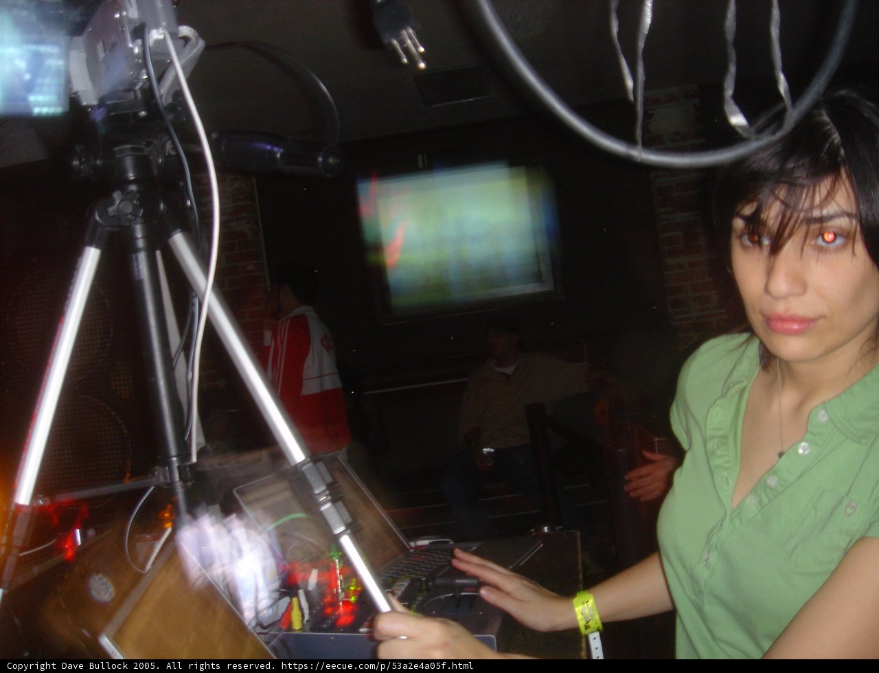 Green Shirt Woman in Electronics Store