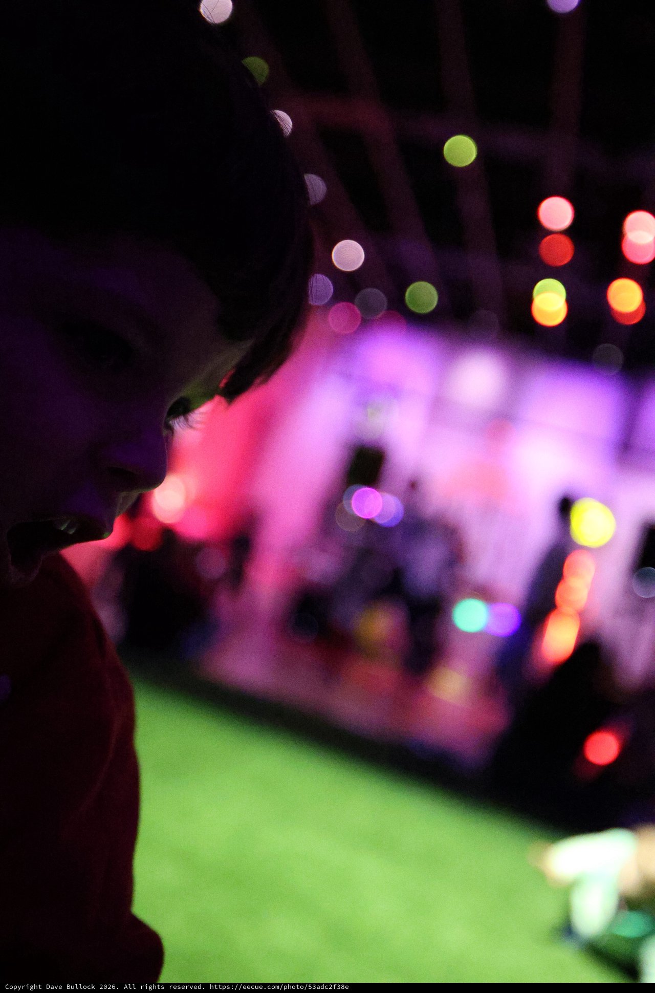 Silhouette Against Colorful Bokeh Lights at Baby Rave