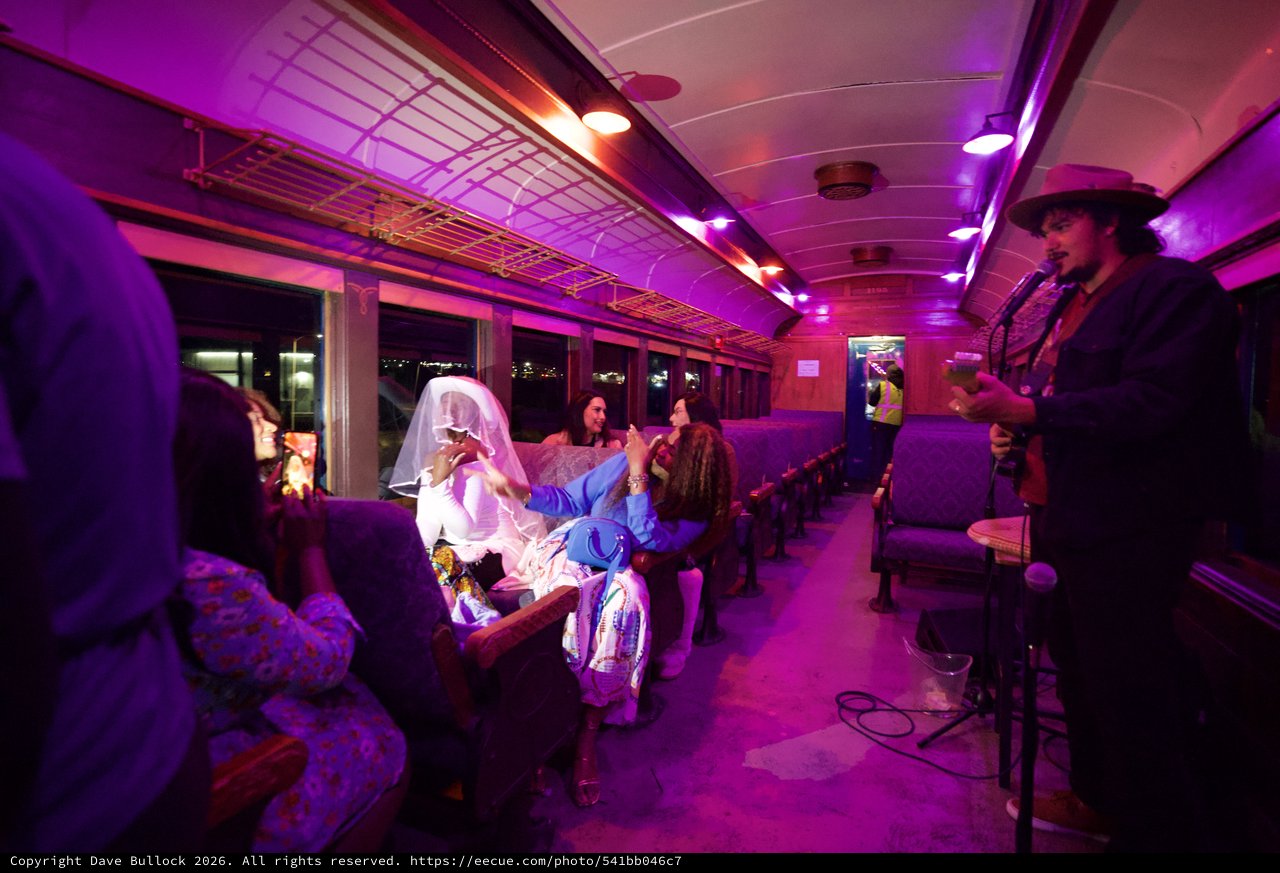 Theatrical Train Journey with Purple Lighting and Costumed Performers