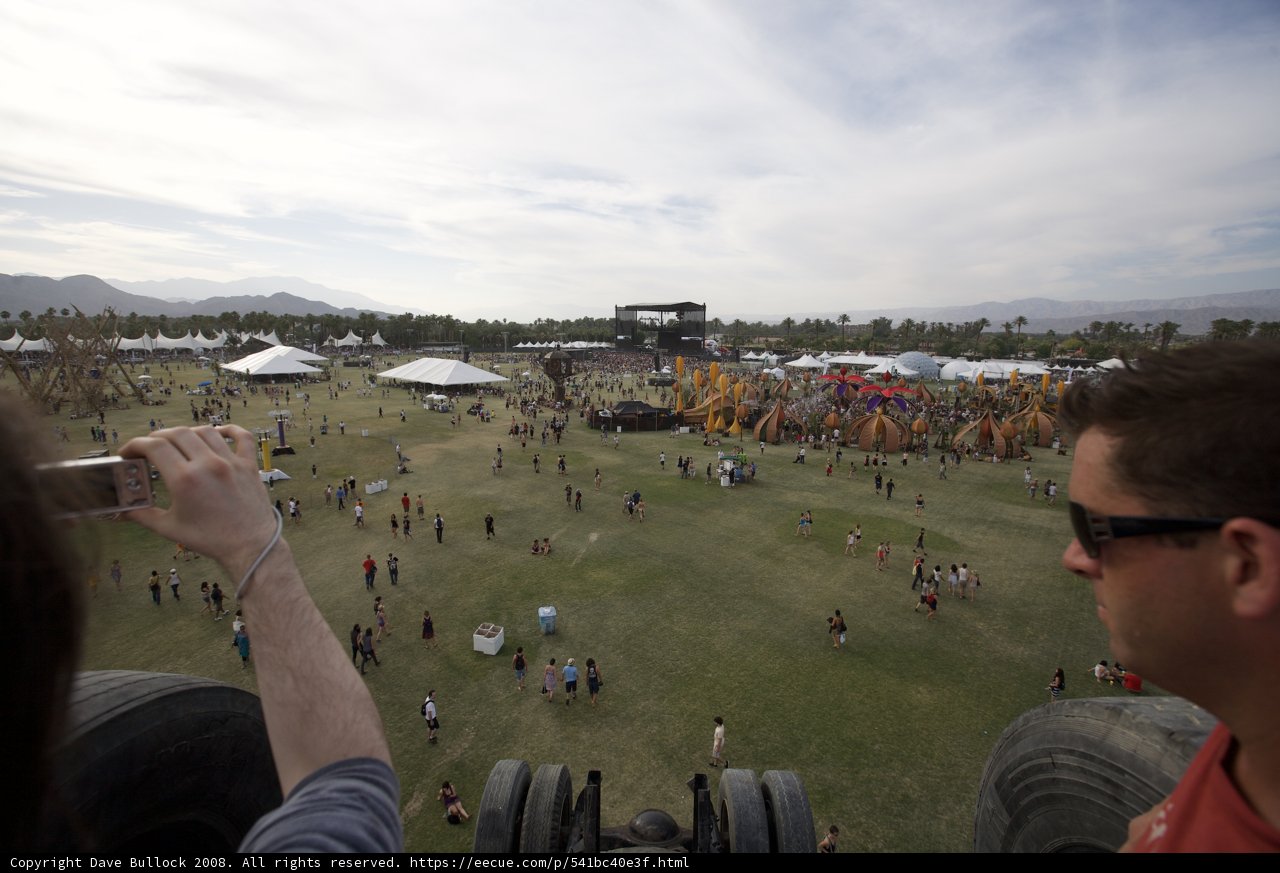 Capturing the Beat: Man Snaps Photo of Music Festival Crowd