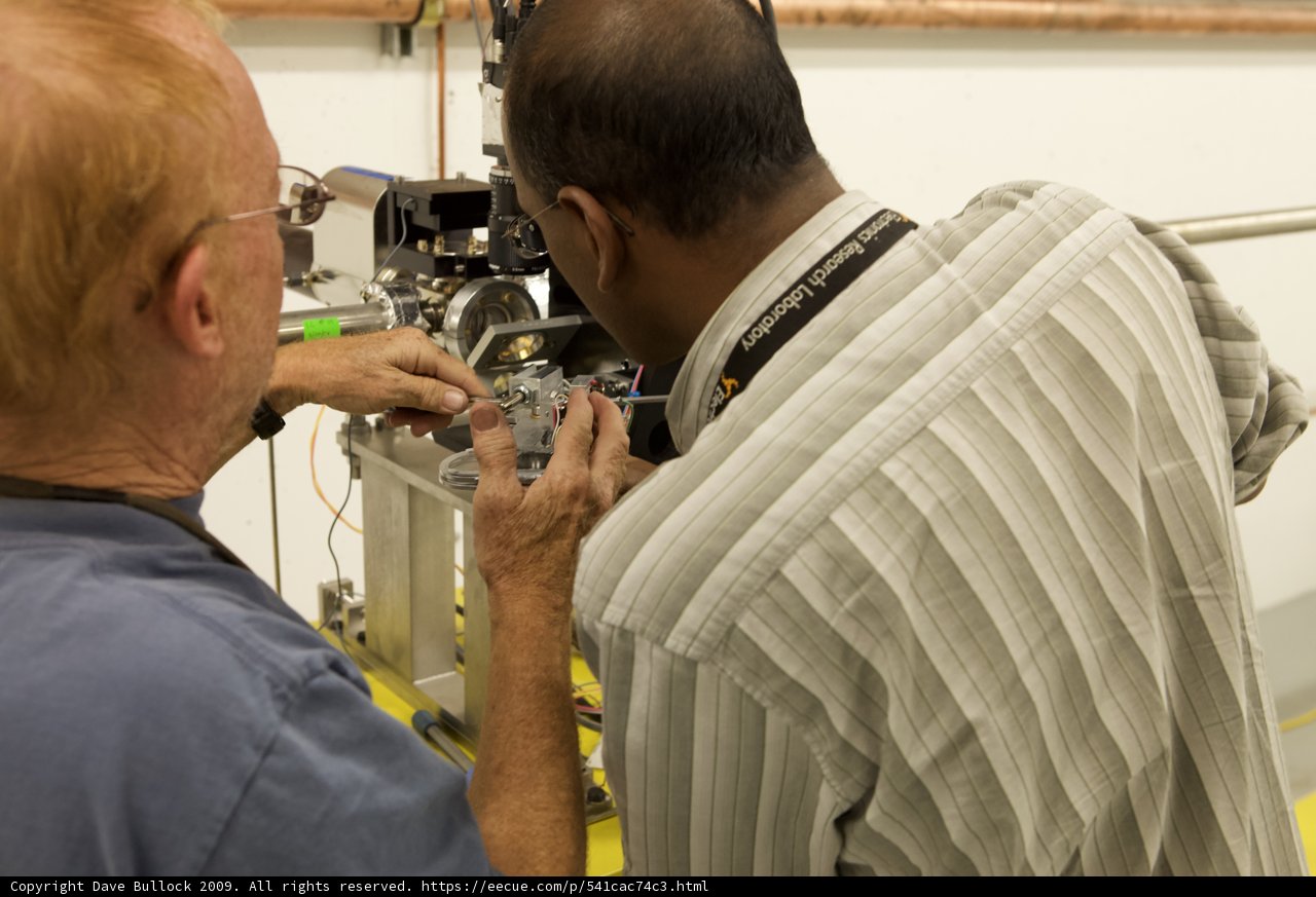 Factory Workers Fine-Tuning the Machine