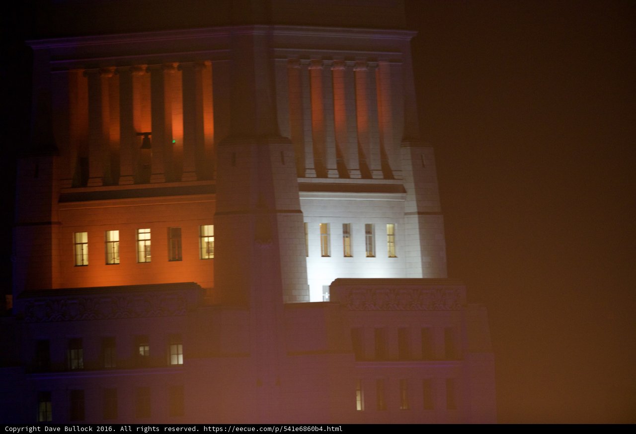 Illuminated Clock Tower in the Urban Jungle