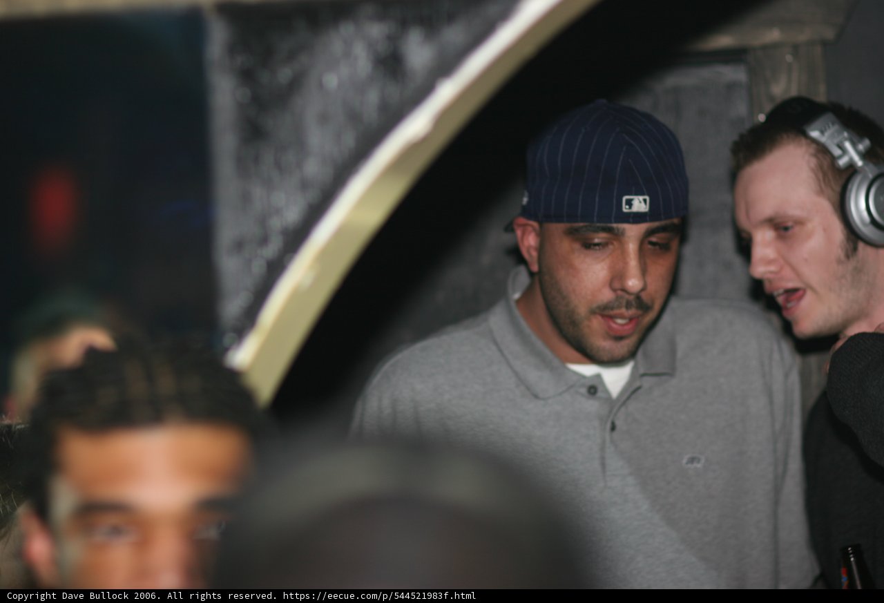 Men in Caps Discussing in the Club