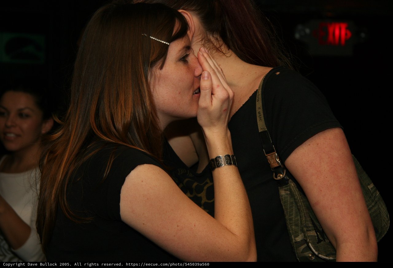 Two Women Share an Intimate Kiss at Nightclub