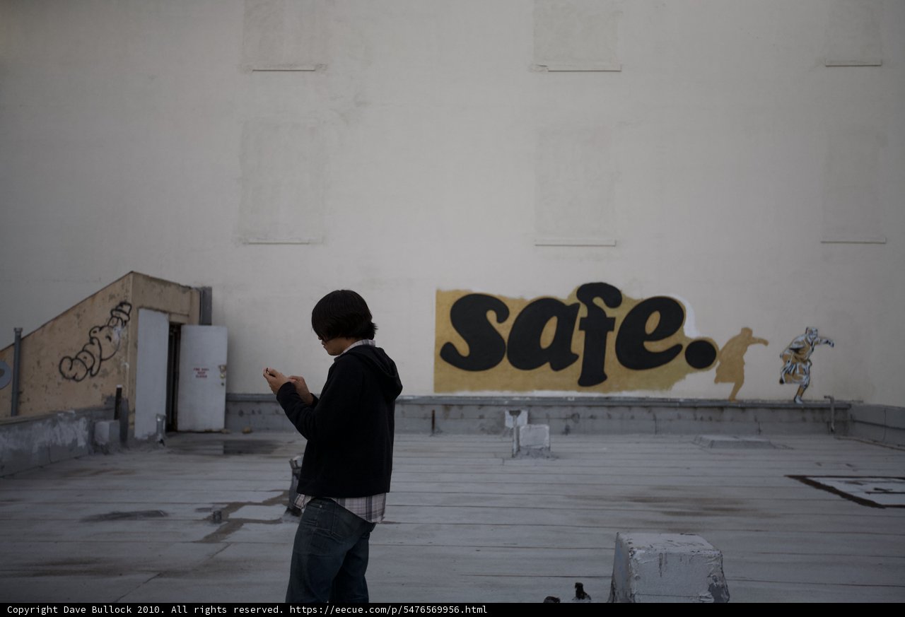 Man on Roof, Text Message in Hand