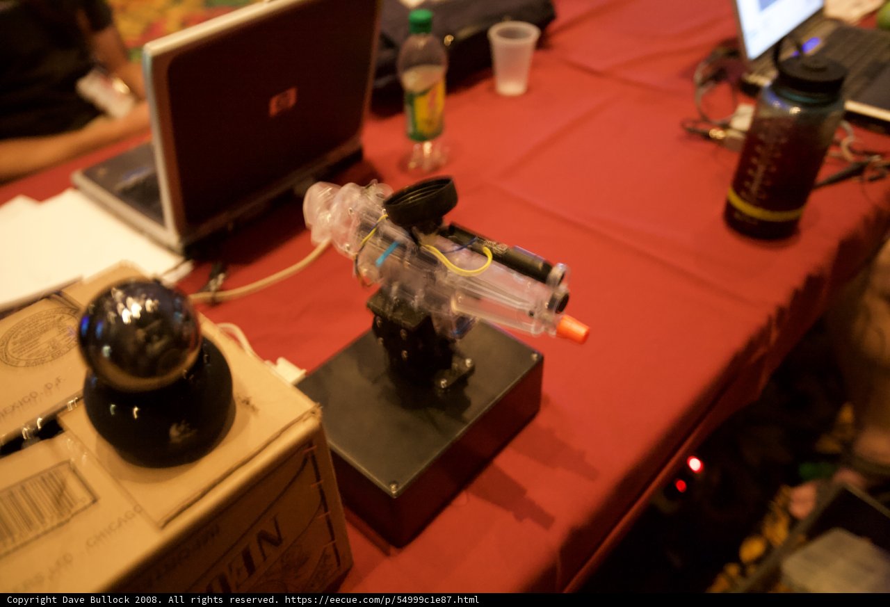 Red Table with Laptop and Gun