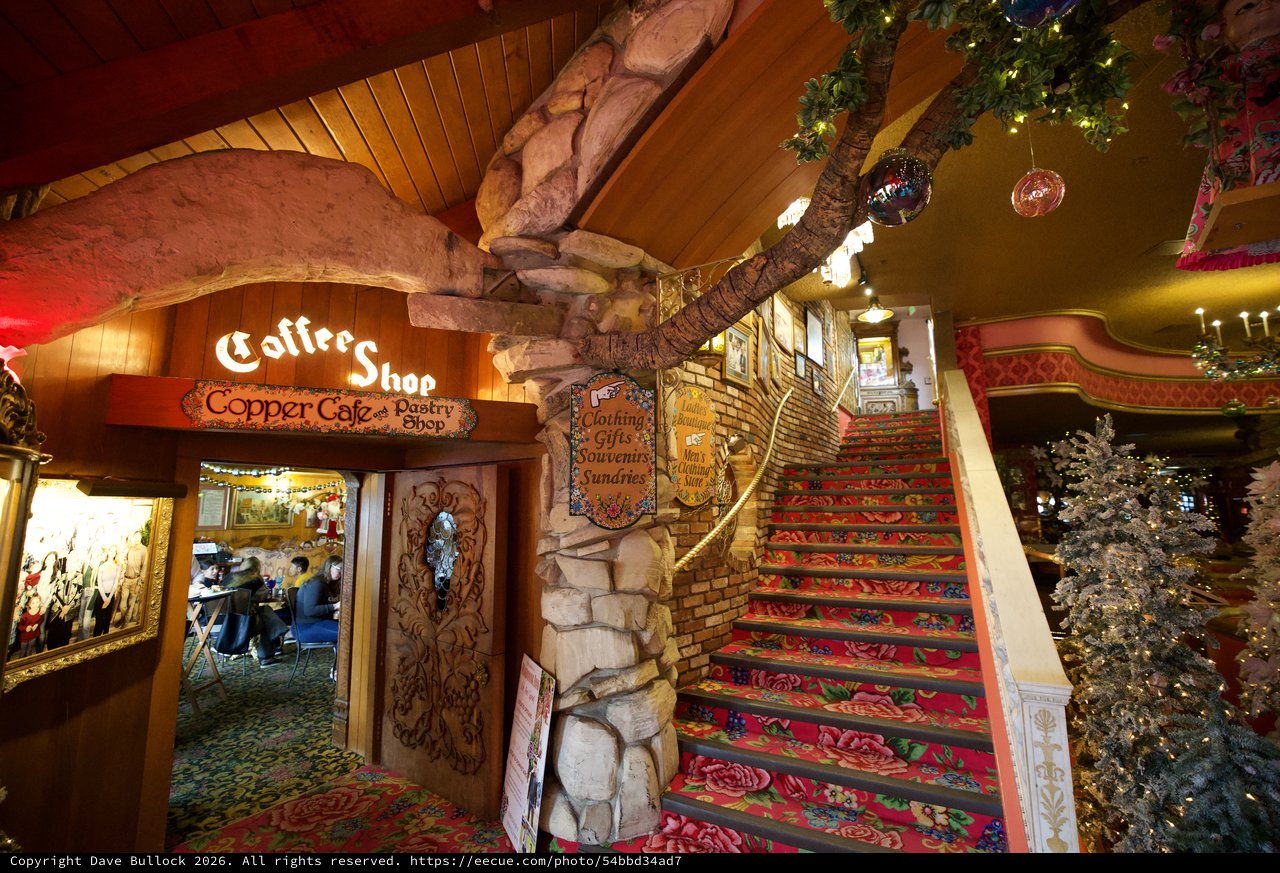 Whimsical Coffee Shop with Vibrant Floral Staircase